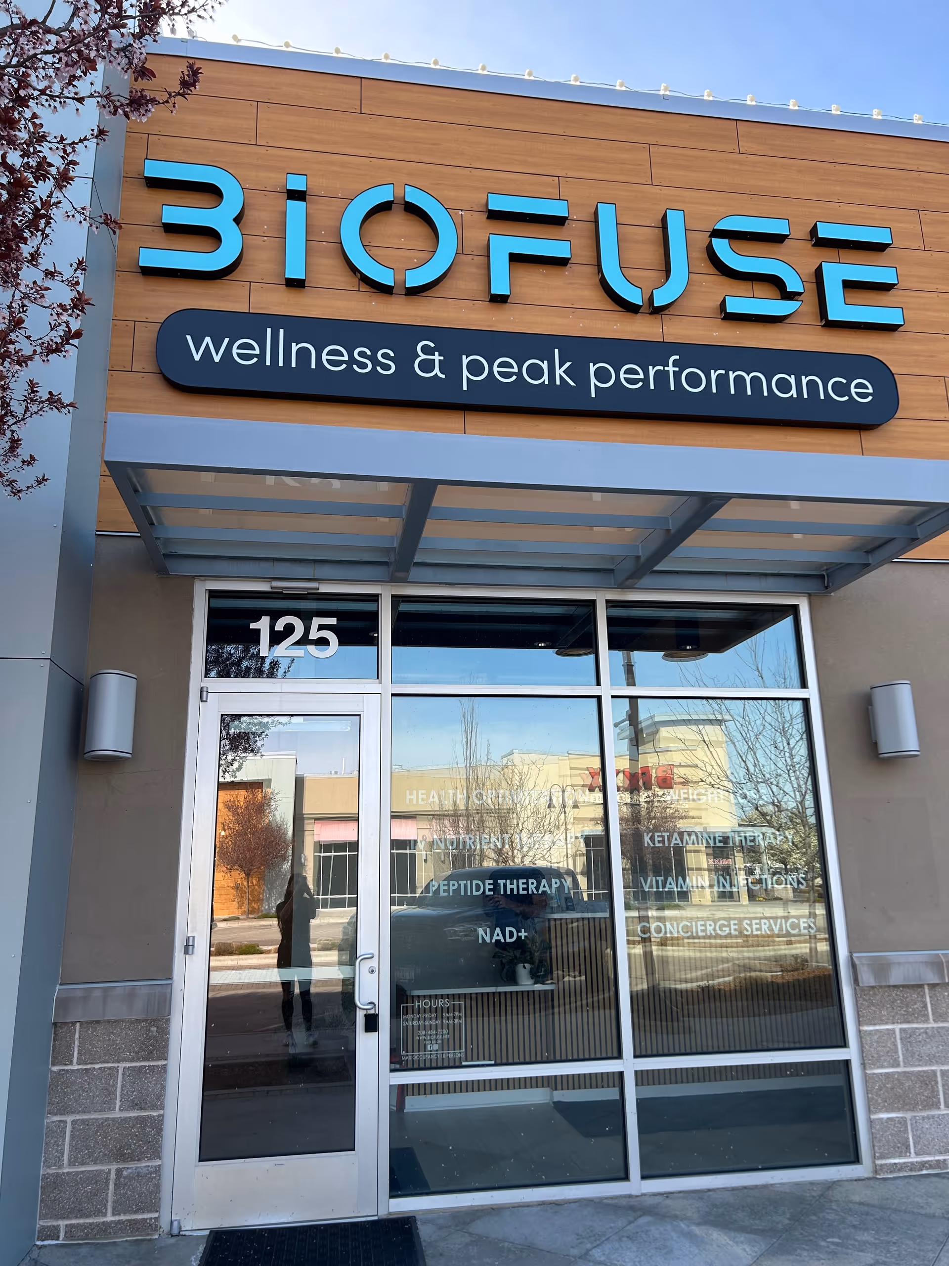 Exterior view of Biofuse wellness center entrance with glass doors and signage.