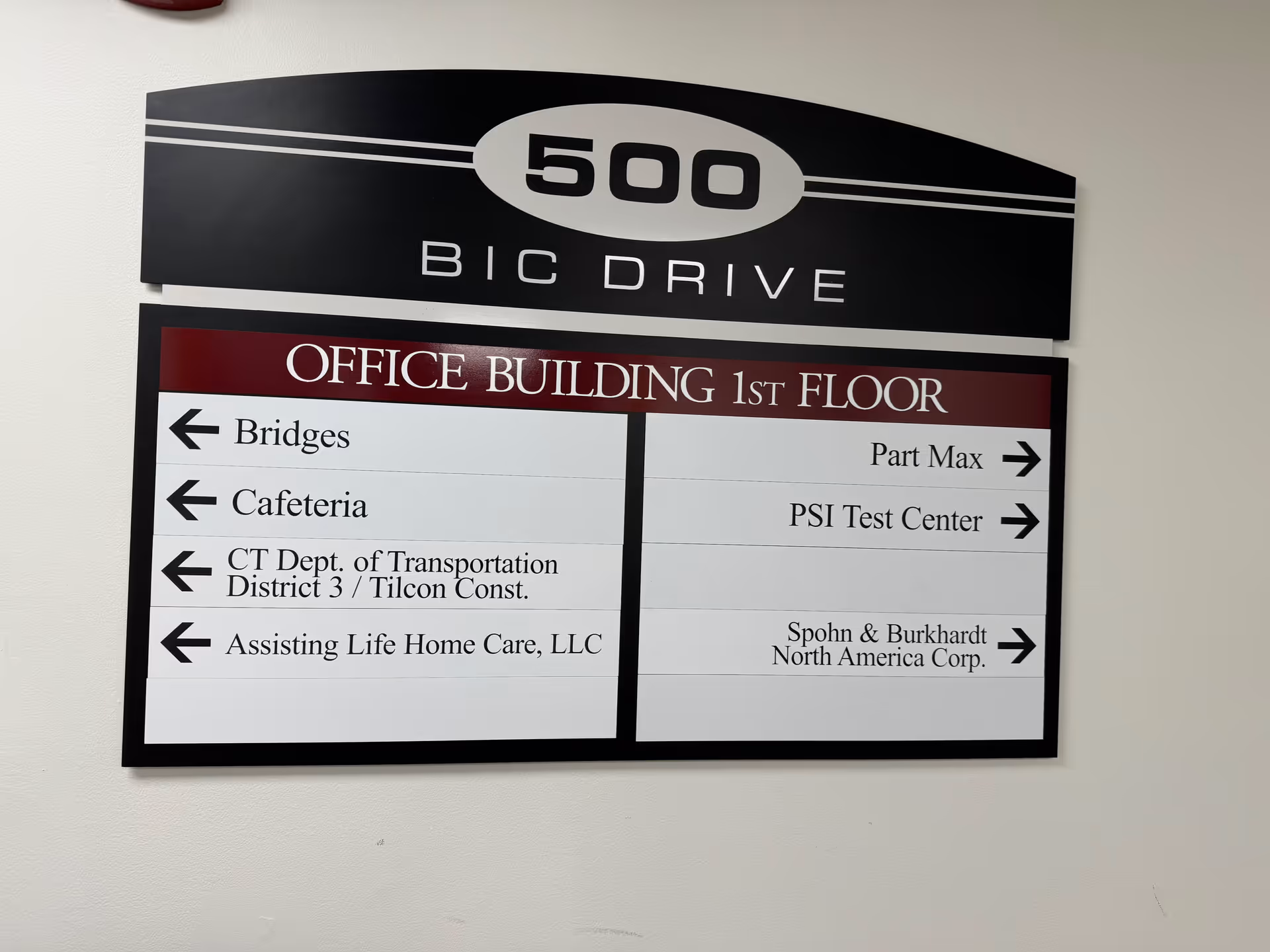 Interior hallway signboard listing offices and directions, including Assisting Life Home Care, LLC.
