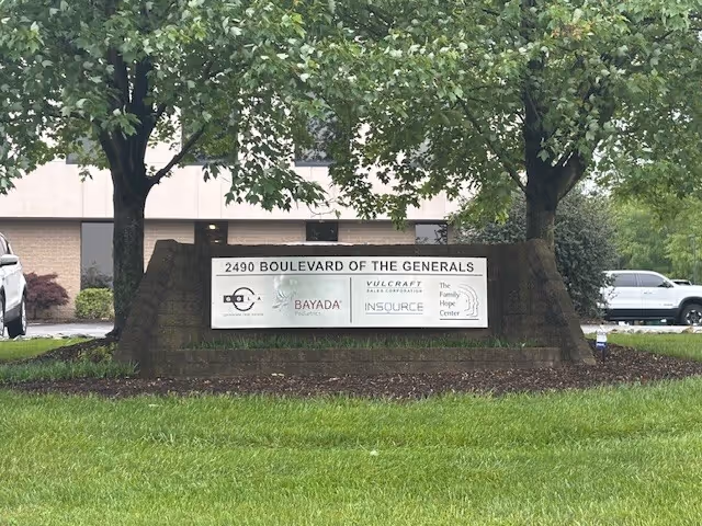 Sign for Valley Forge Skilled at the building entrance with trees