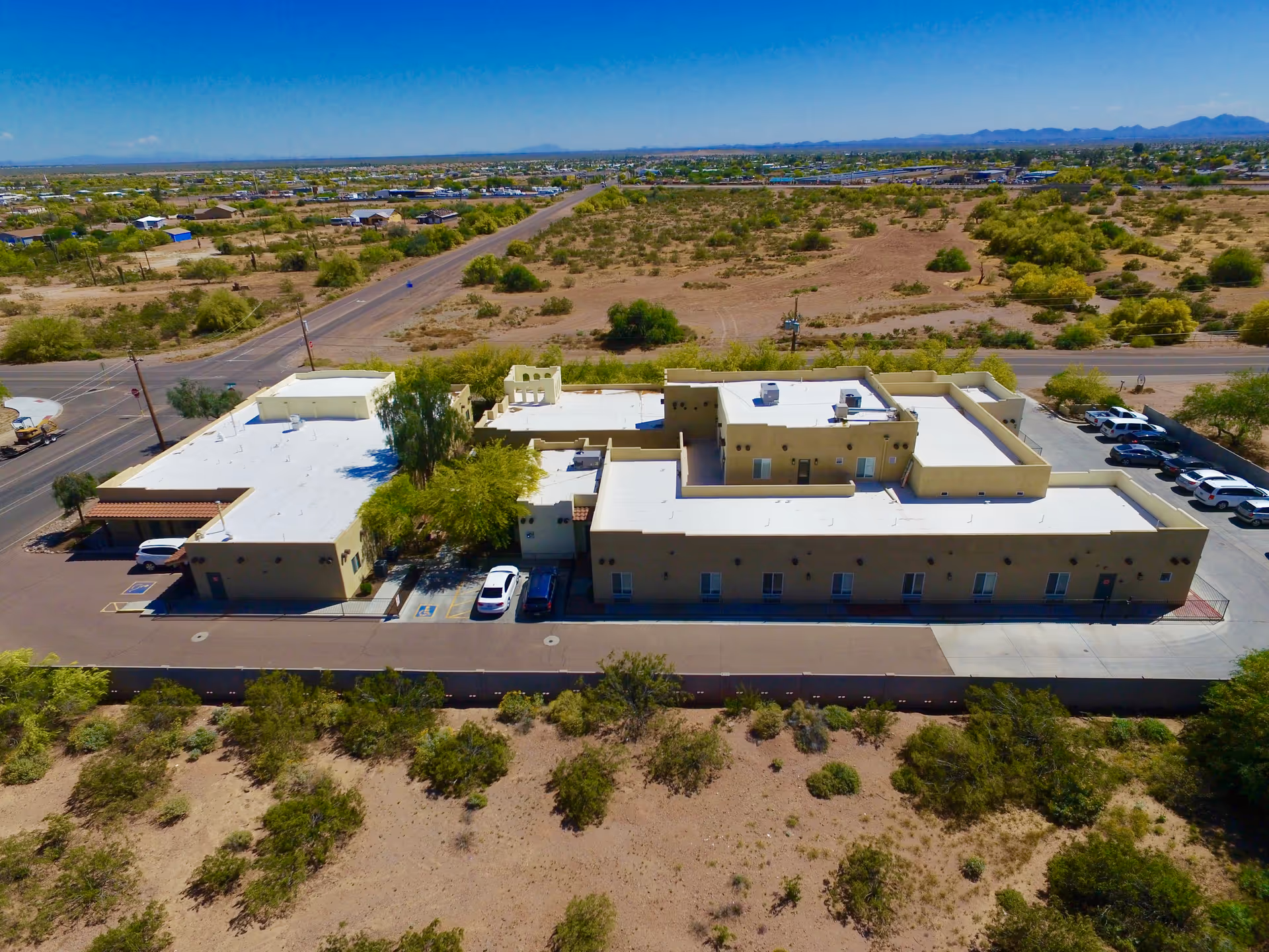 Aerial view of Visions Senior Living at Apache Junction exterior complex amid desert