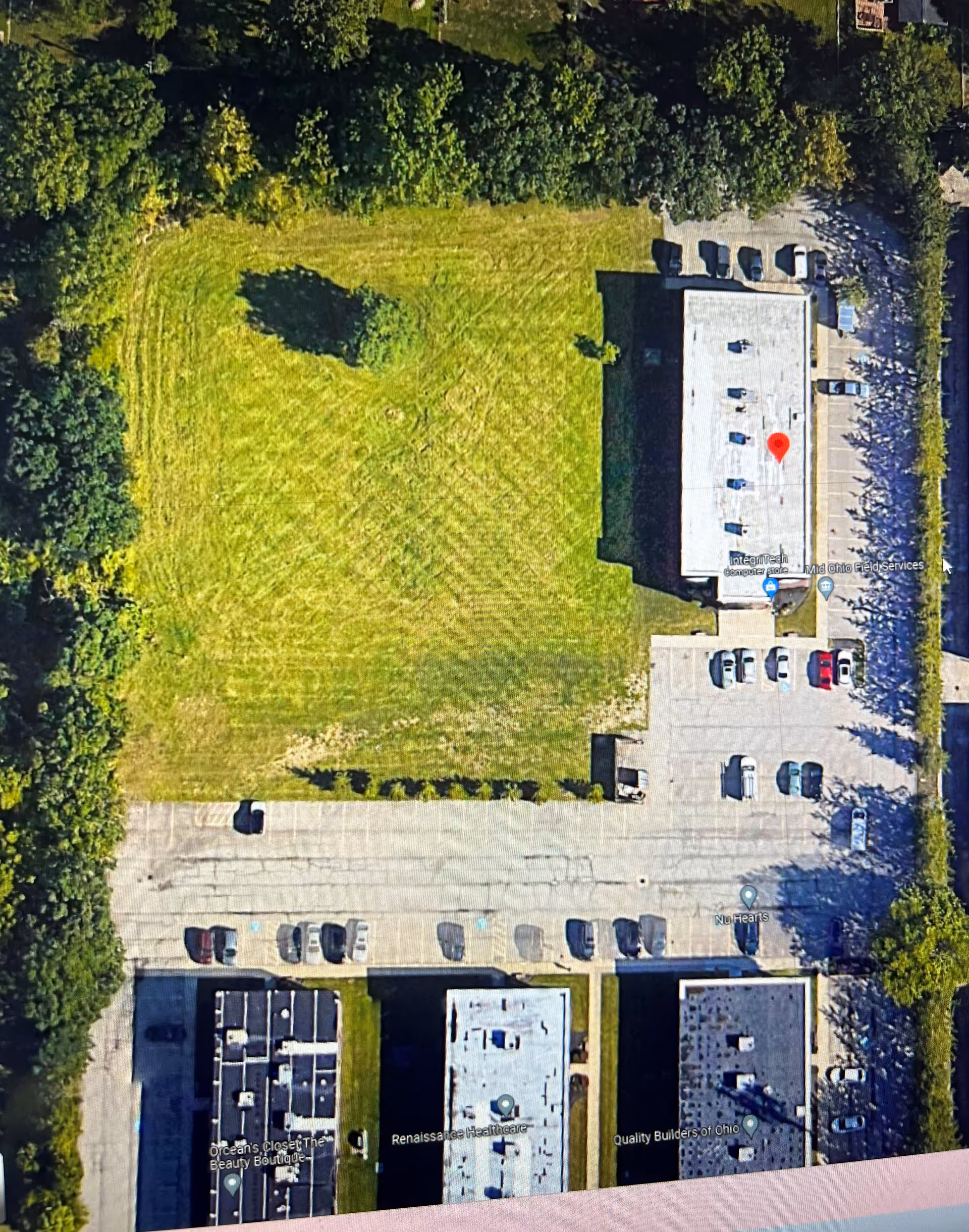Aerial view of Madison Home Health Services building with surrounding parking and grassy lot.