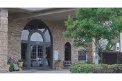 Friendship Haven facility entrance with arched glass doors and brick exterior.