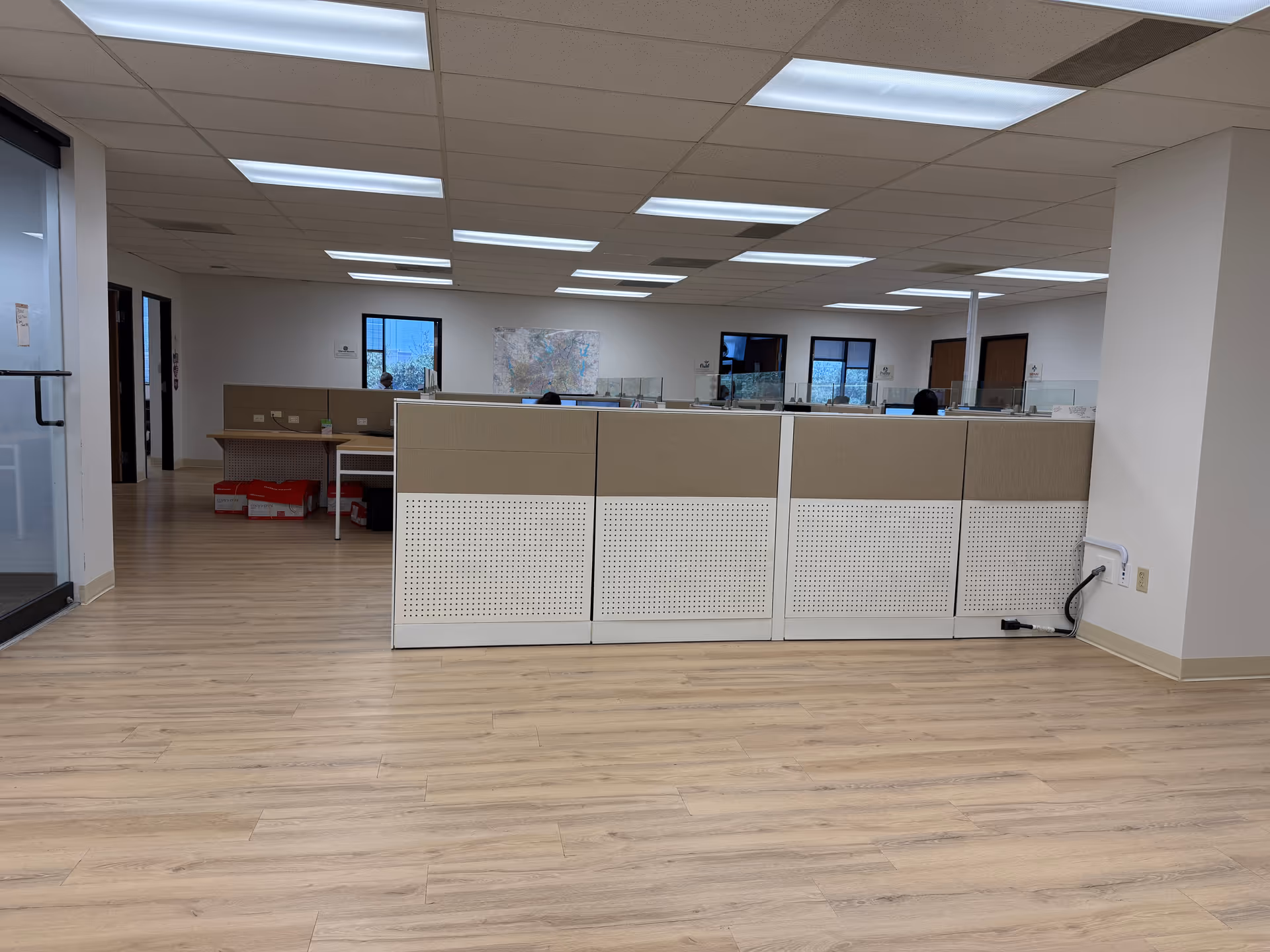 Reception area of Anointed Healthcare Group Inc with cubicle desks and neutral decor.