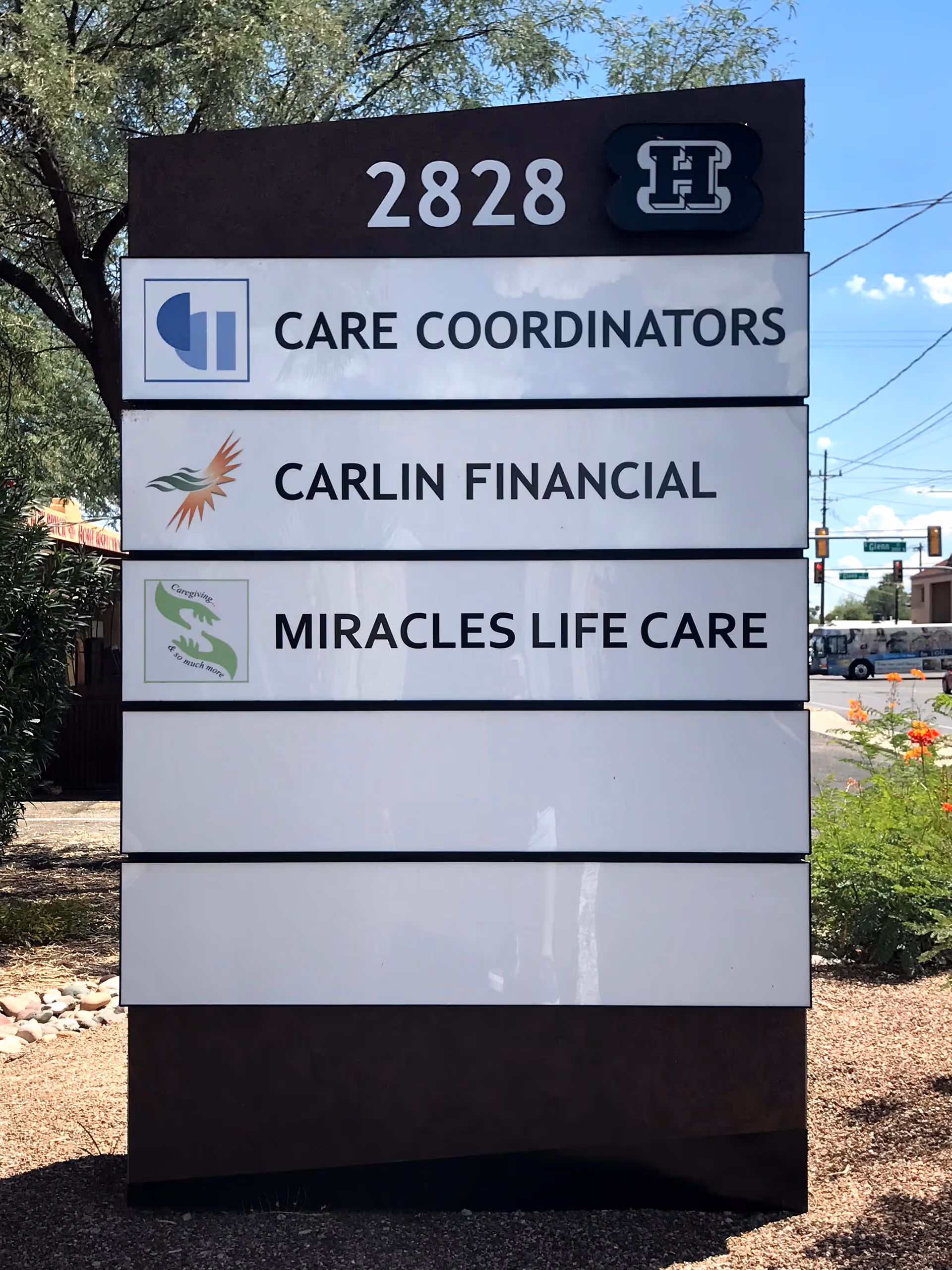 Outdoor multi-panel sign for Miracles Life Care with 2828 address