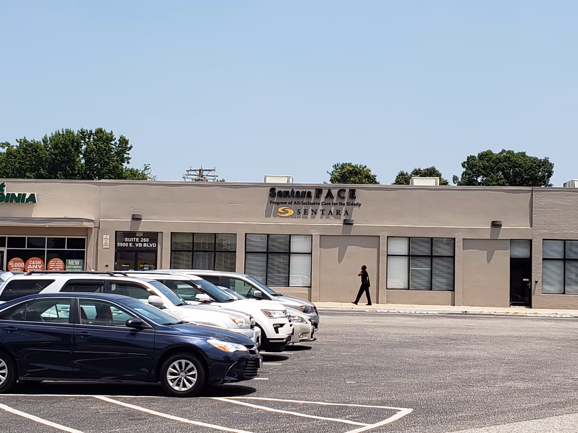 Exterior of Sentara PACE building with parked cars in front