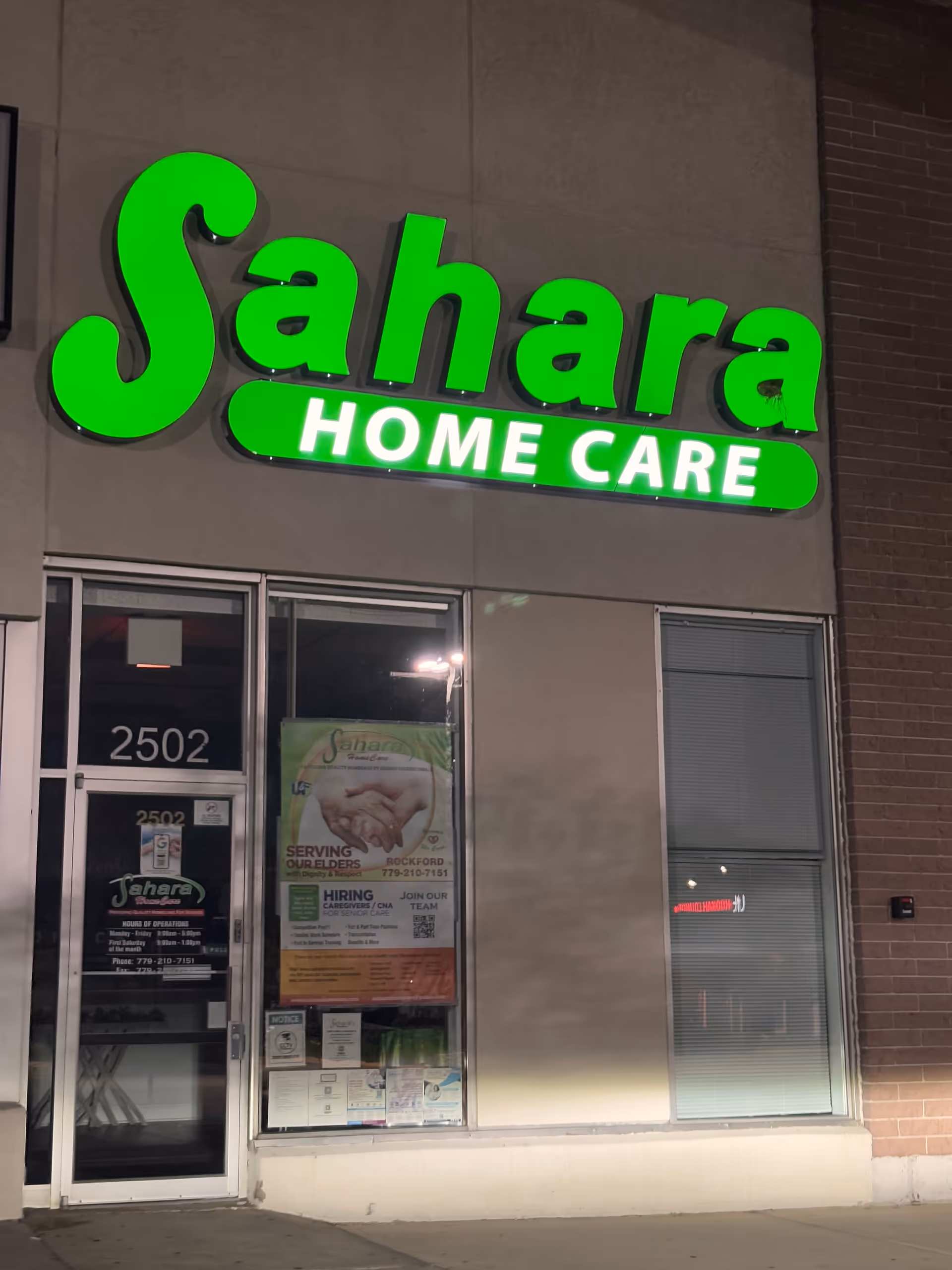 Exterior view of Sahara Home Care storefront with a bright green sign above the entrance.