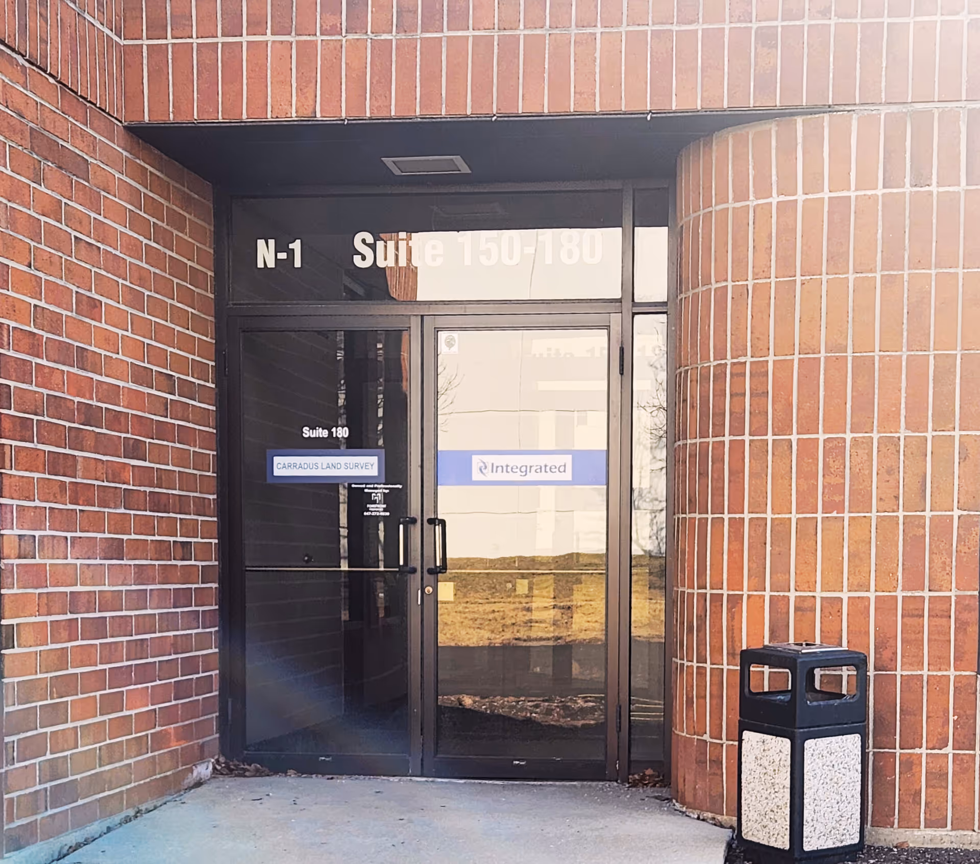 Brick exterior entrance with glass doors labeled N-1 Suite 150-180 for Integrated Respiratory Solutions.