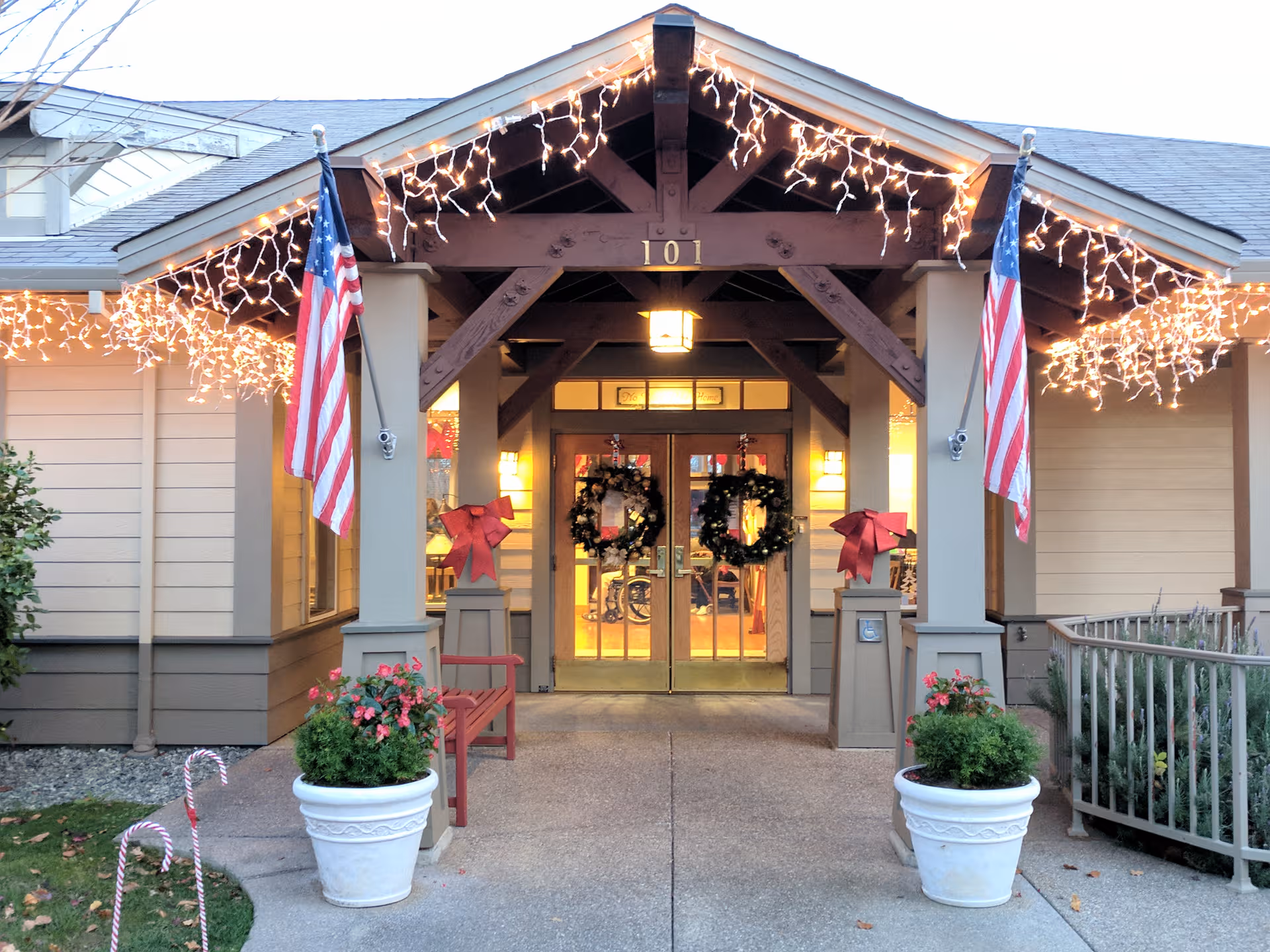 Oakdale Heights Assisted Living entrance illuminated with holiday lights and wreaths.