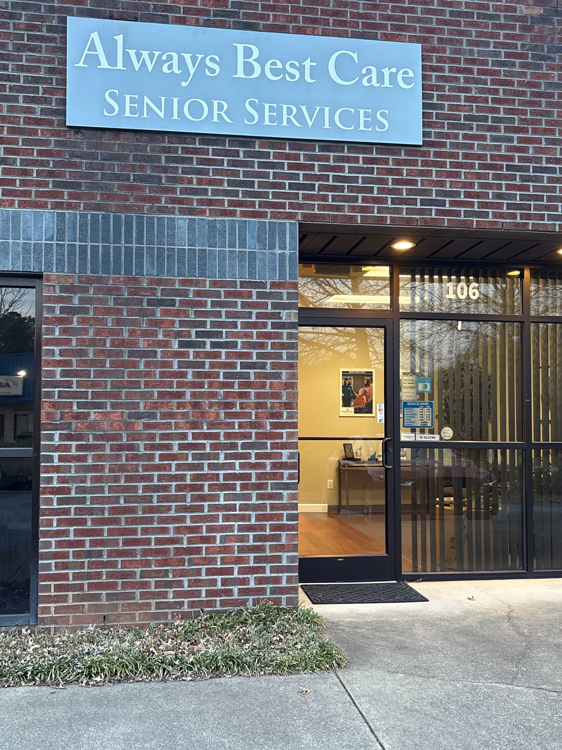 Brick building exterior with Always Best Care Senior Services sign and glass entrance.