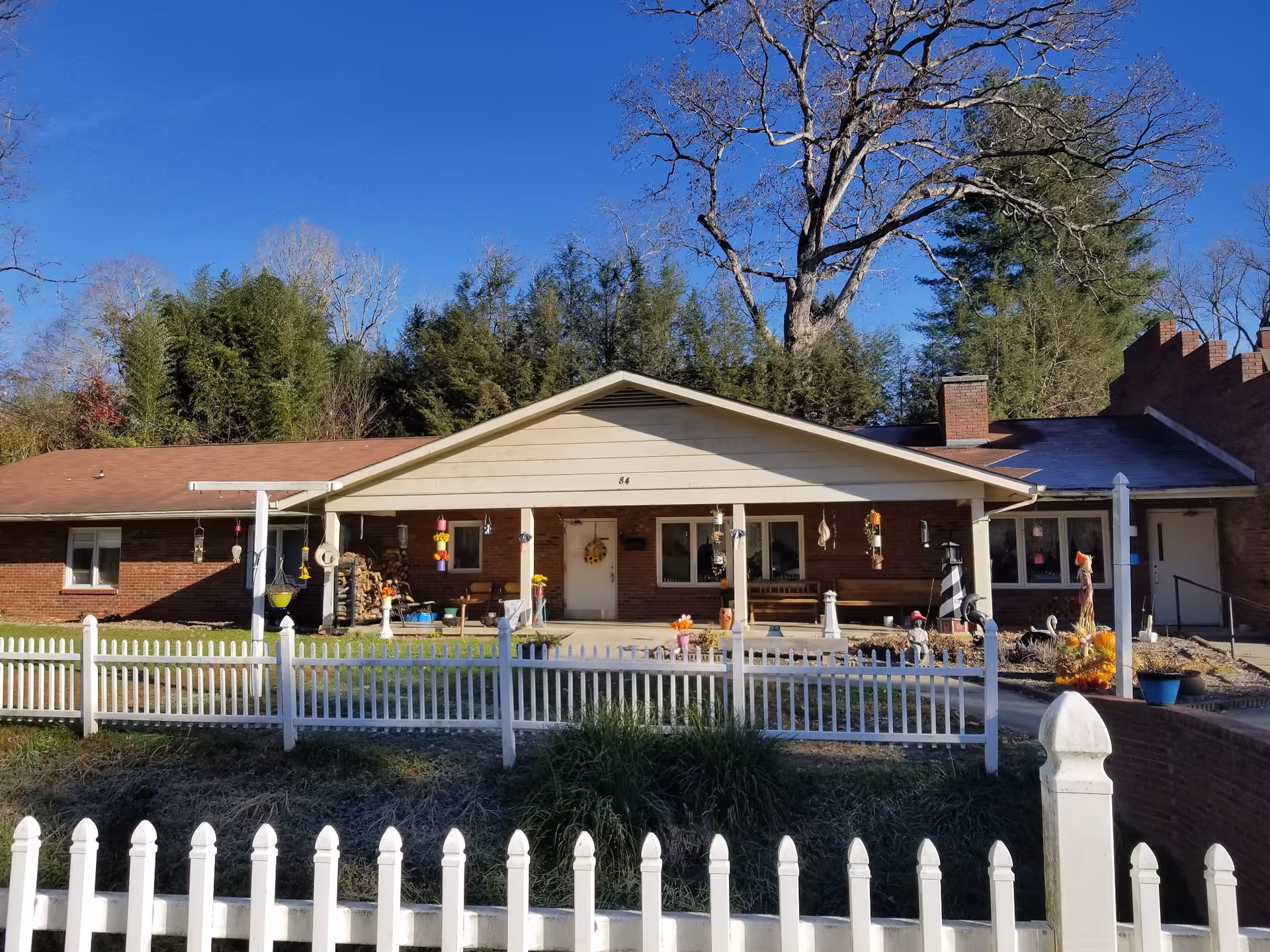 Exterior view of Chestnut Park Retirement Center, a brick facility with a white picket fence.