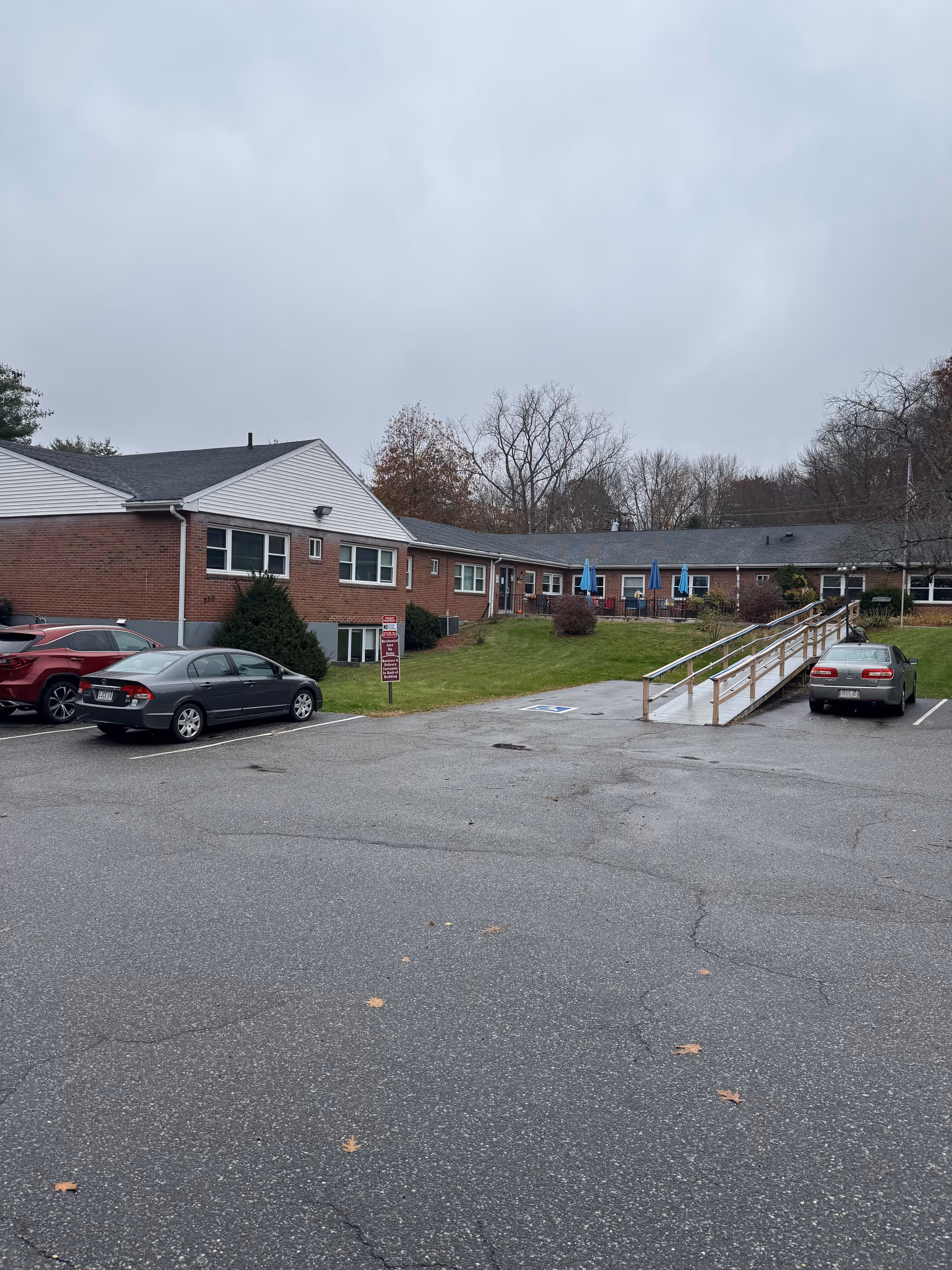 Exterior view of Palmer Healthcare Center with brick building, parking lot, and accessible ramp