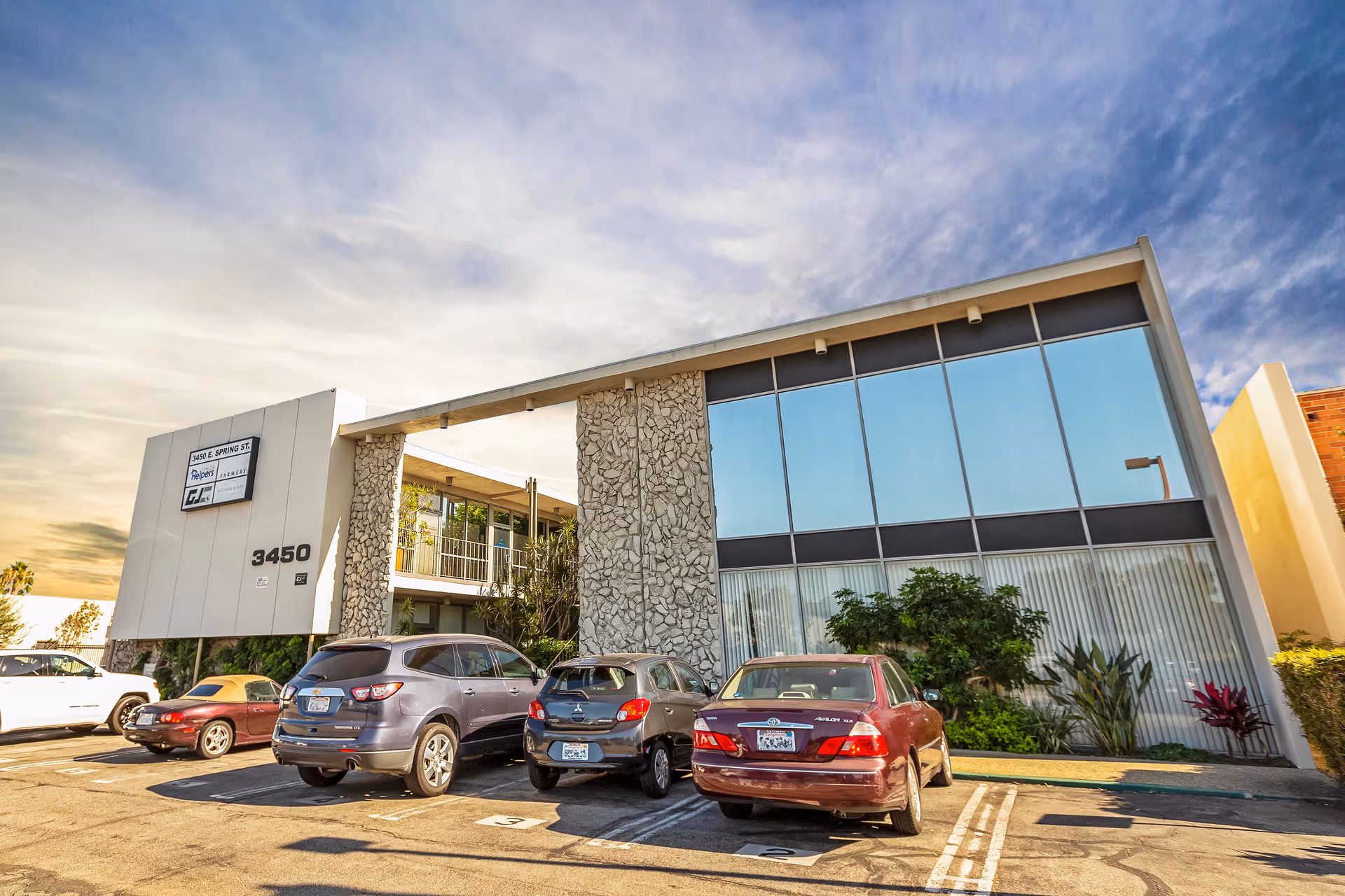 Exterior view of Senior Helpers of Long Beach facility with parked cars.