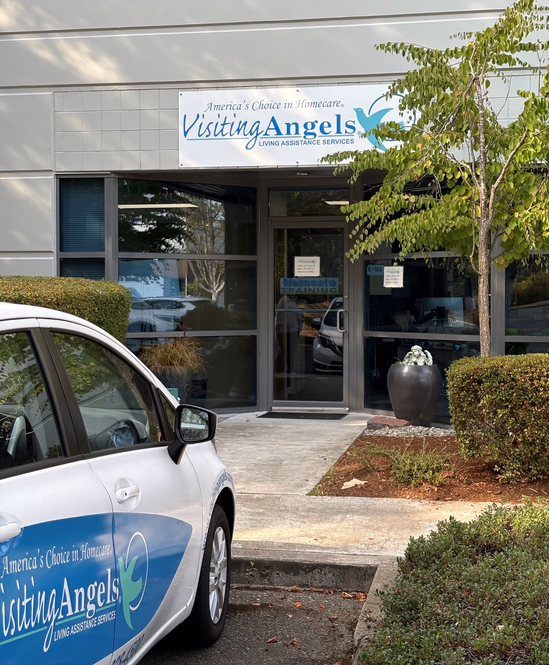 Front entrance of Visiting Angels Eastside with a parked car and landscaped shrubs.