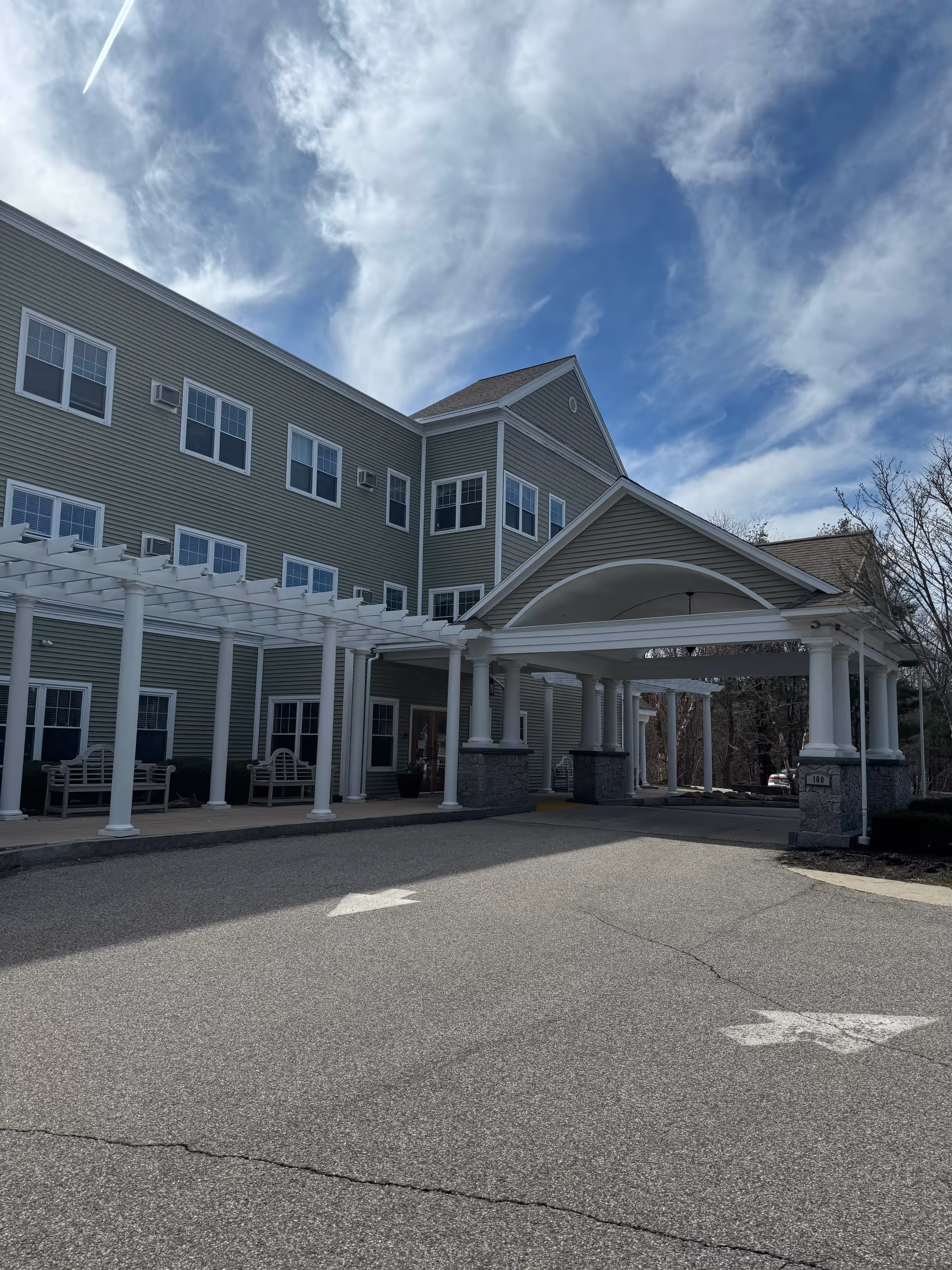 Exterior view of Inn at Atlantic Heights, a green building with white columns.