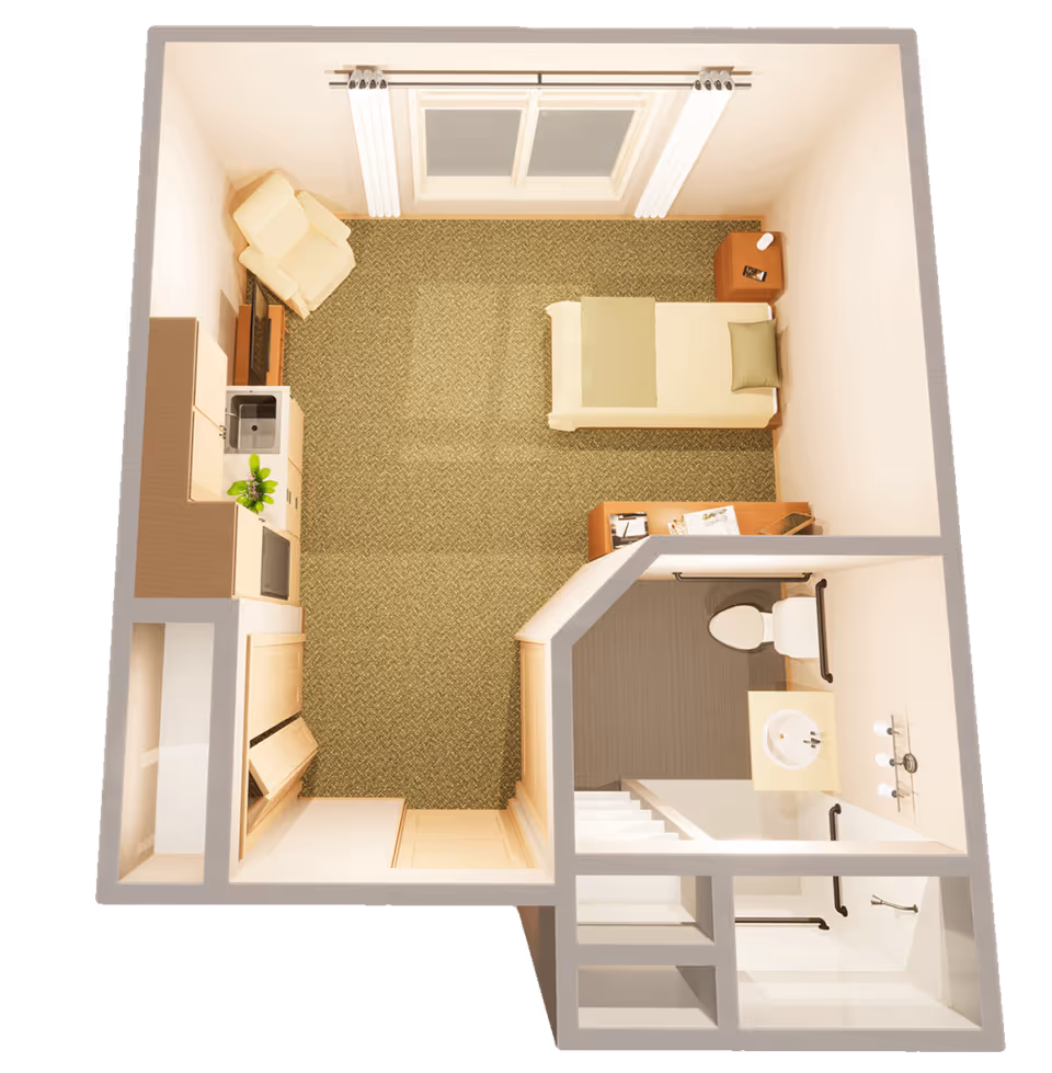 Top-down view of a small assisted living studio apartment featuring a single bed with a pillow and blanket, a nightstand with a lamp and phone, a small desk with papers and a tablet, a recliner chair, a kitchenette with a sink and microwave, and an attached bathroom with a toilet, sink, and shower equipped with grab bars.