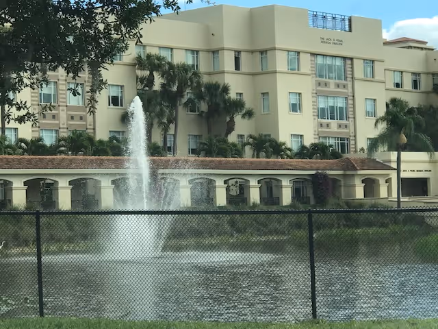 Front view of MorseLife Health System building with fountain and palm trees