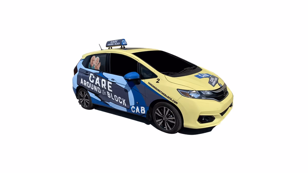 A branded Care Around The Block service car with yellow and blue wrap.