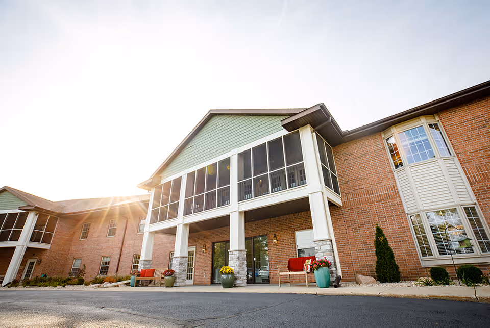 Front exterior of Sage Meadow of Middleton, brick building with large windows and planters.