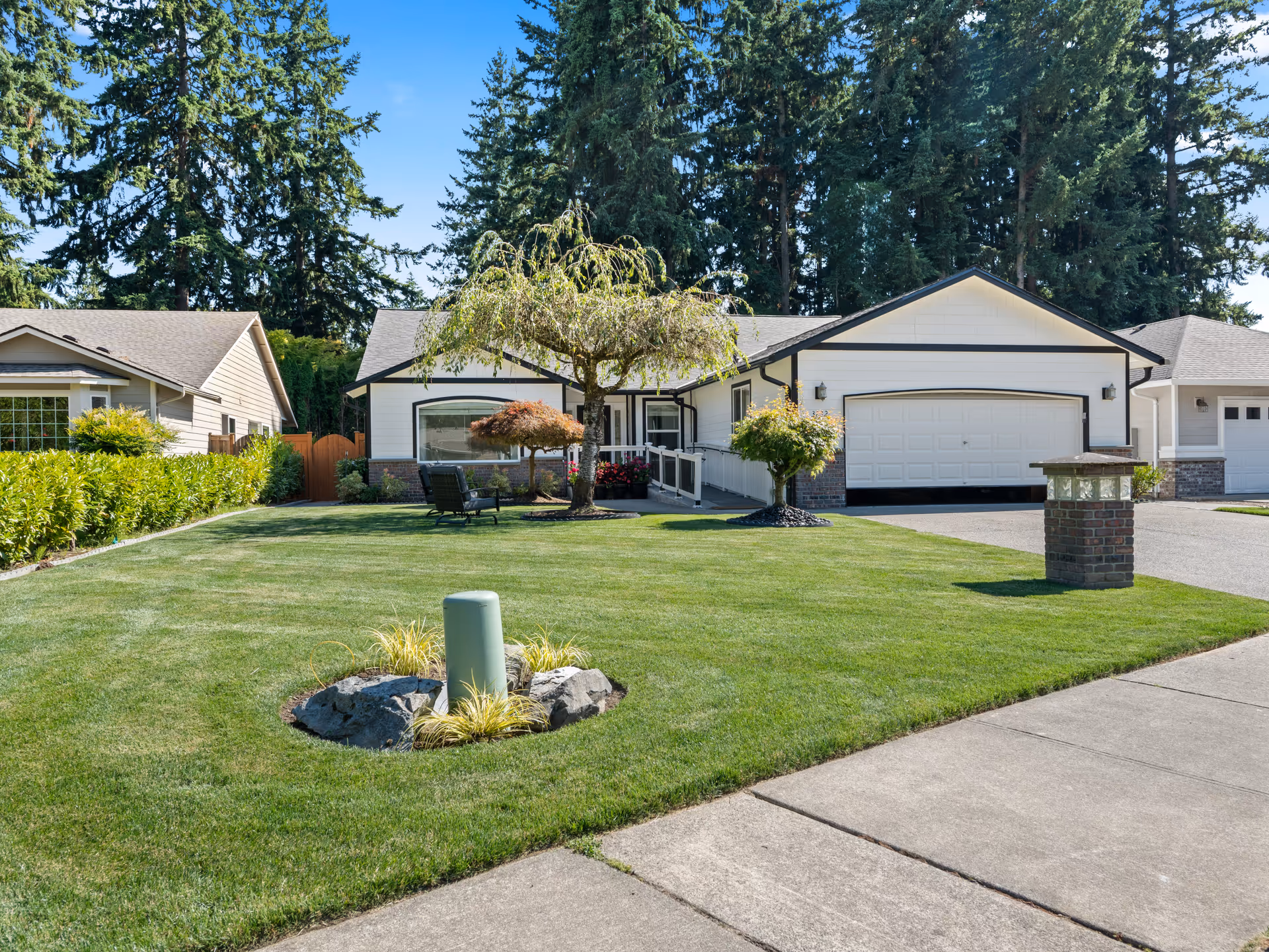 Exterior view of a single-story senior living home with manicured lawn and driveway.
