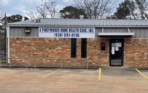 Brick front of A Pineywoods Home Health Care, Inc., with a sign and parking lot.