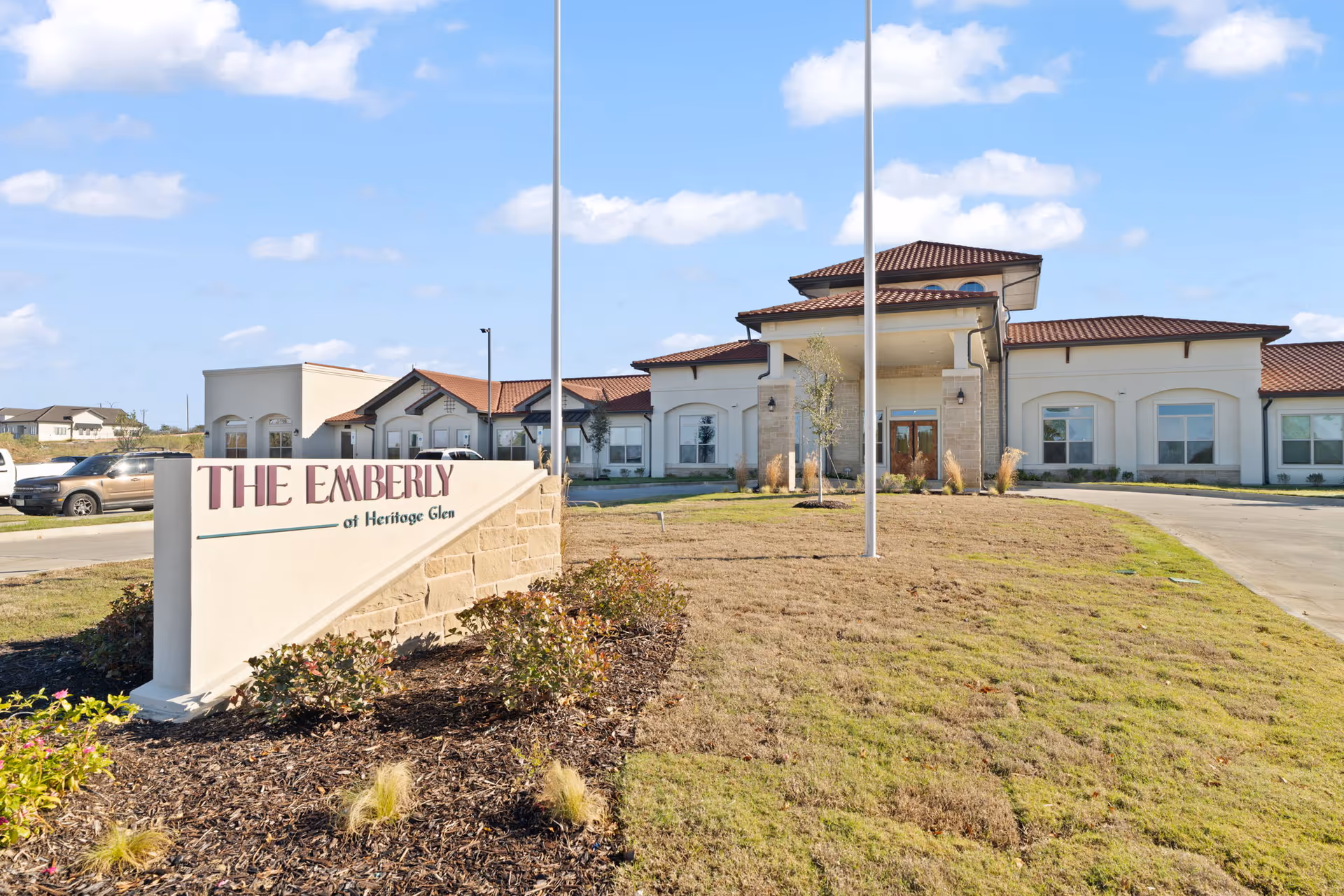 Exterior view of The Emberly at Heritage Glen with the entrance and sign in front.