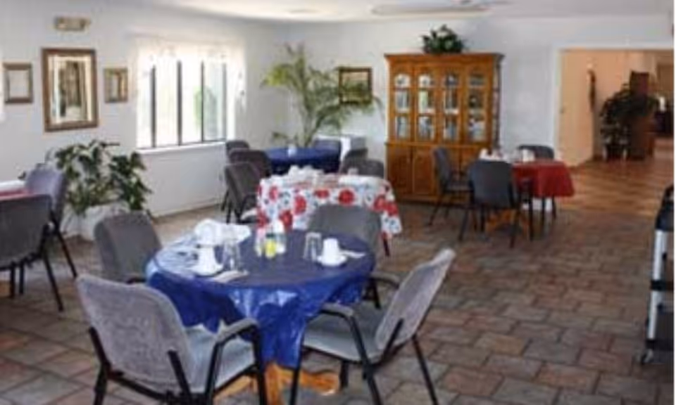 Indoor dining area with round tables, chairs, and a wooden cabinet.