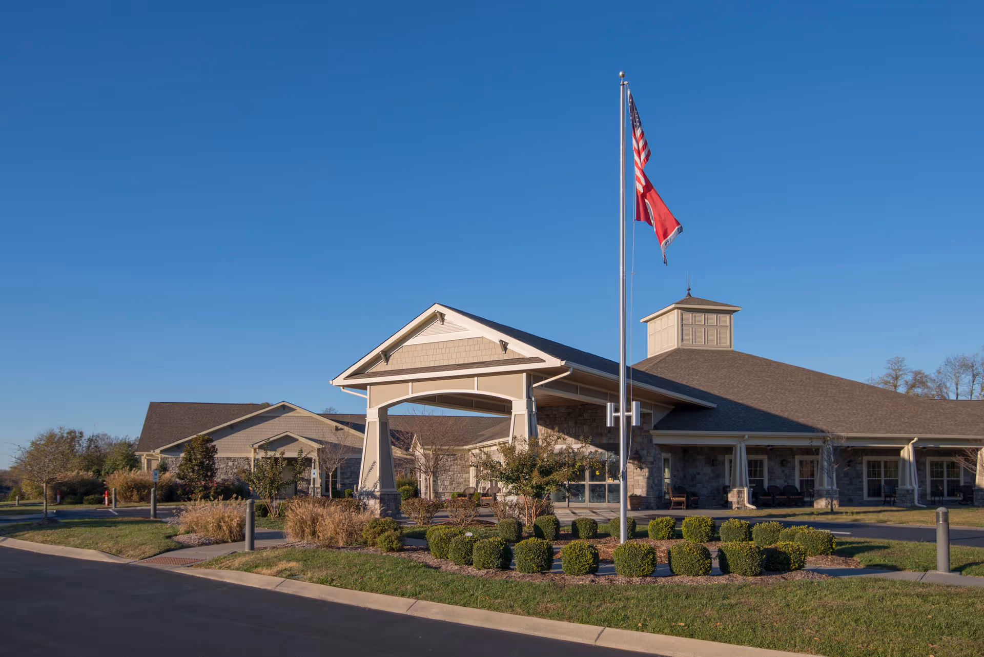 Exterior view of Morning Pointe Brentwood Assisted Living, featuring the entrance and flagpole.