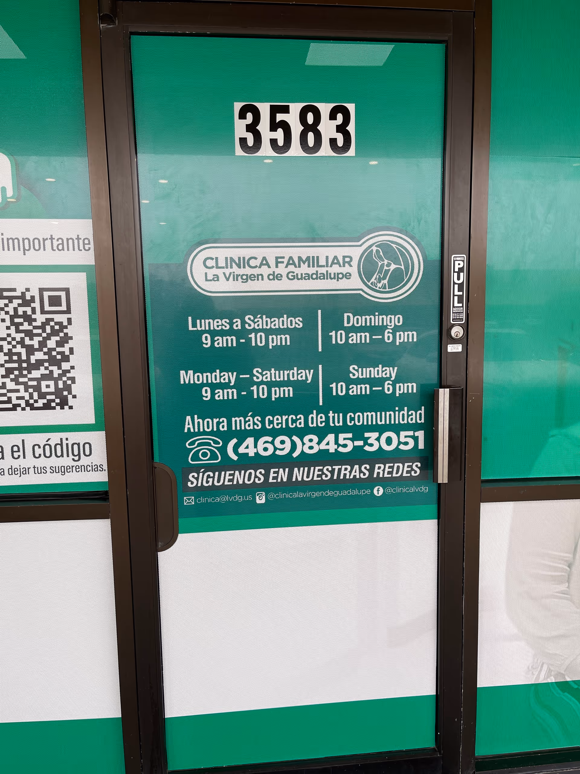 Front entrance door of Clinica Familiar la Virgen de Guadalupe Irving with hours and logo