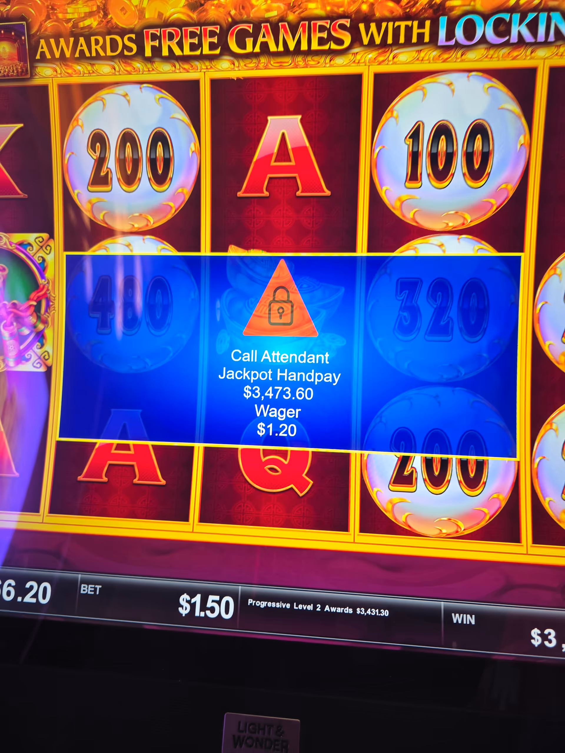 Bright casino slot machine screen displaying a blue jackpot area and various symbols.