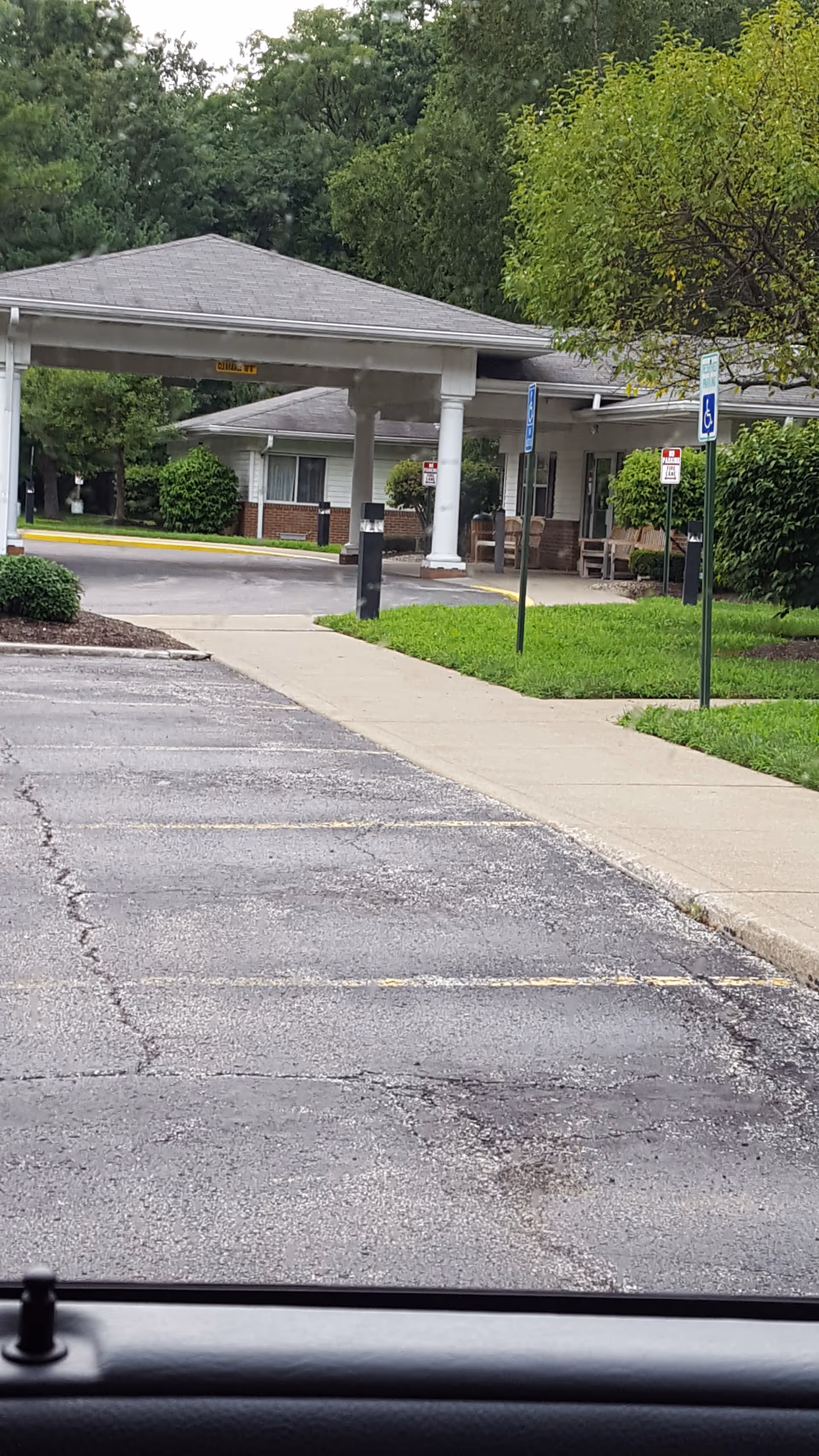 Exterior view of CareCore at Mentor facility with entrance canopy and parking lot.