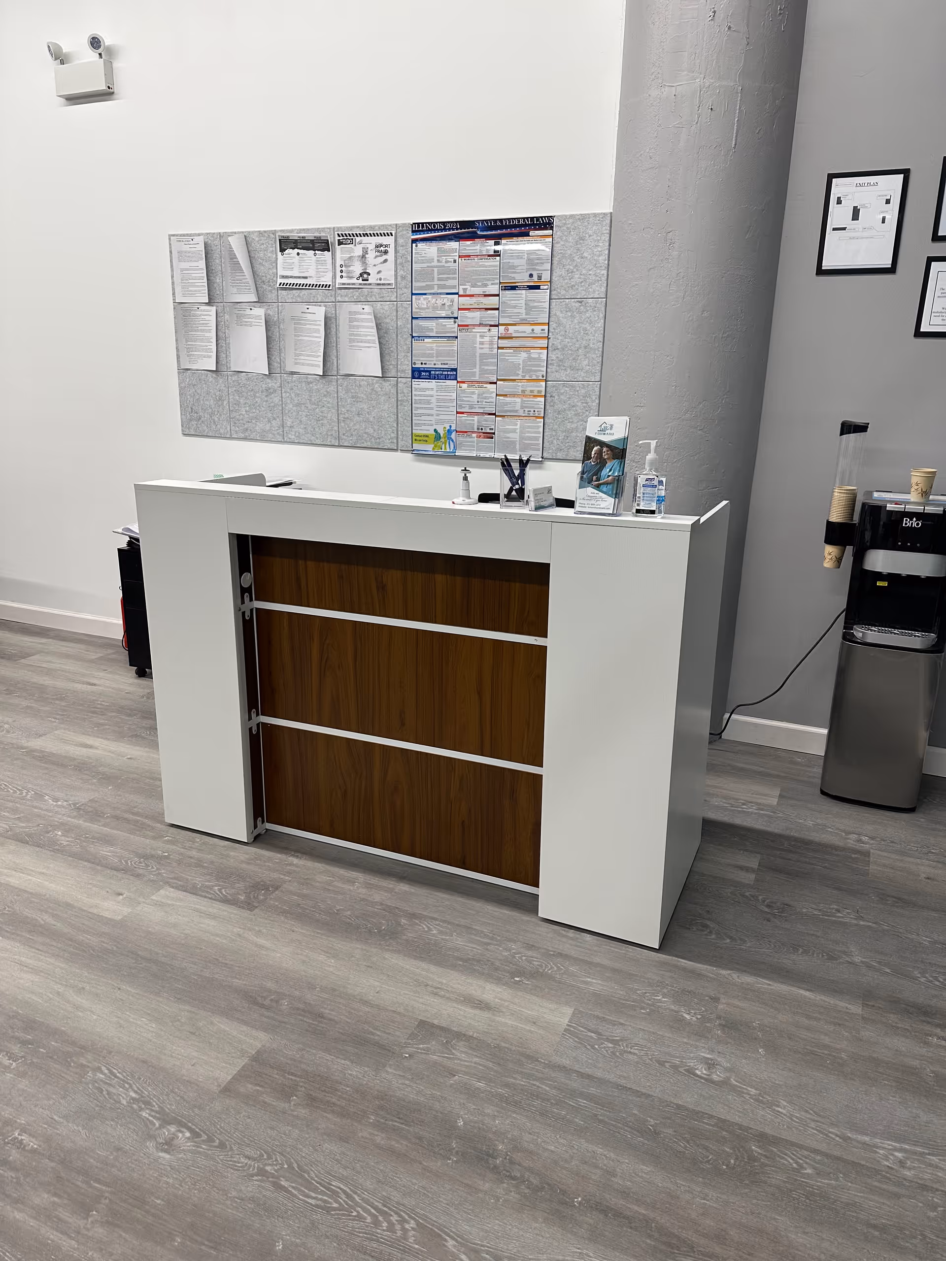 Reception desk with notice boards and a water cooler inside a senior facility
