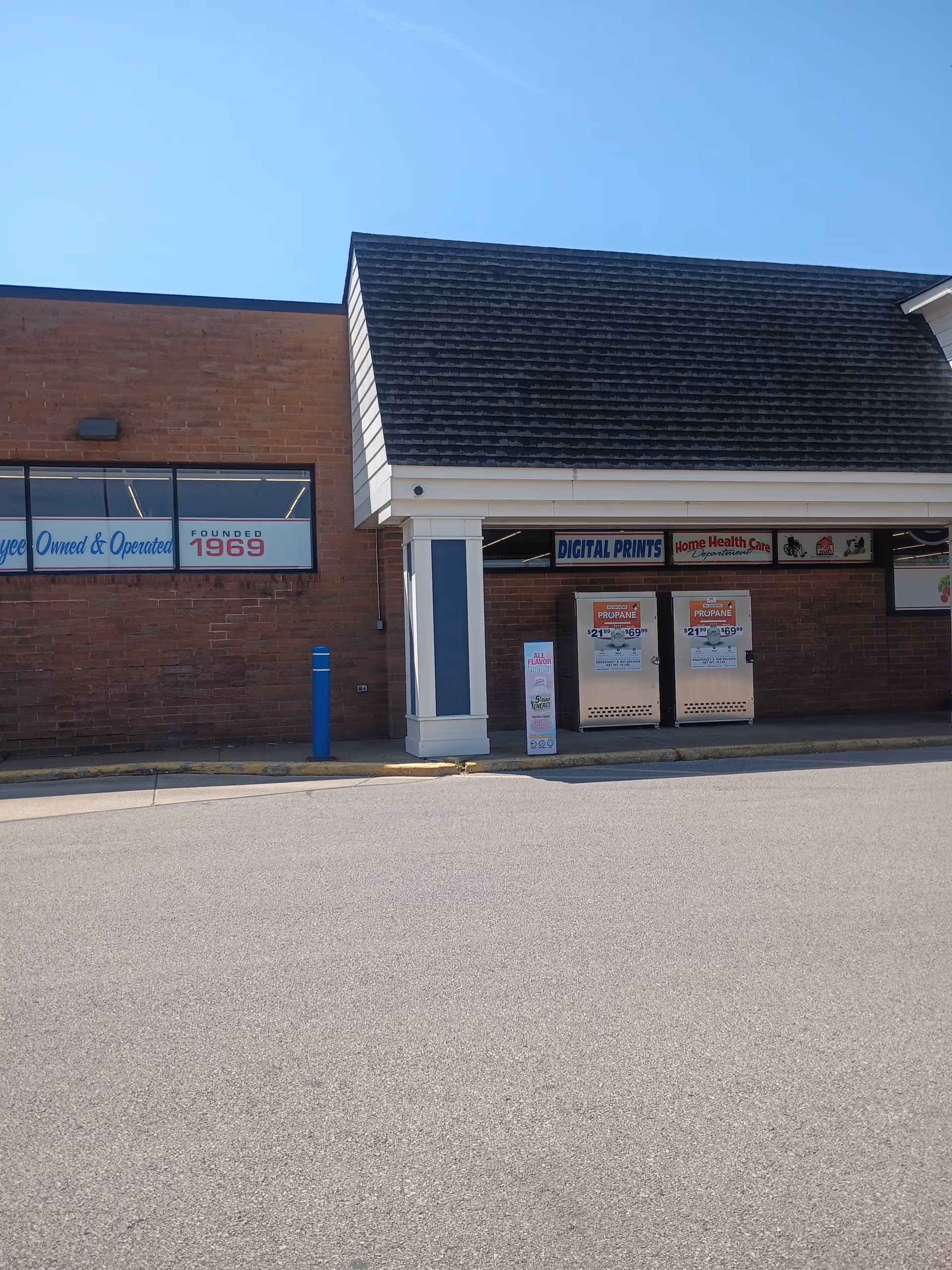 Exterior view of Discount Drug Mart store with brick facade and storefront signage.