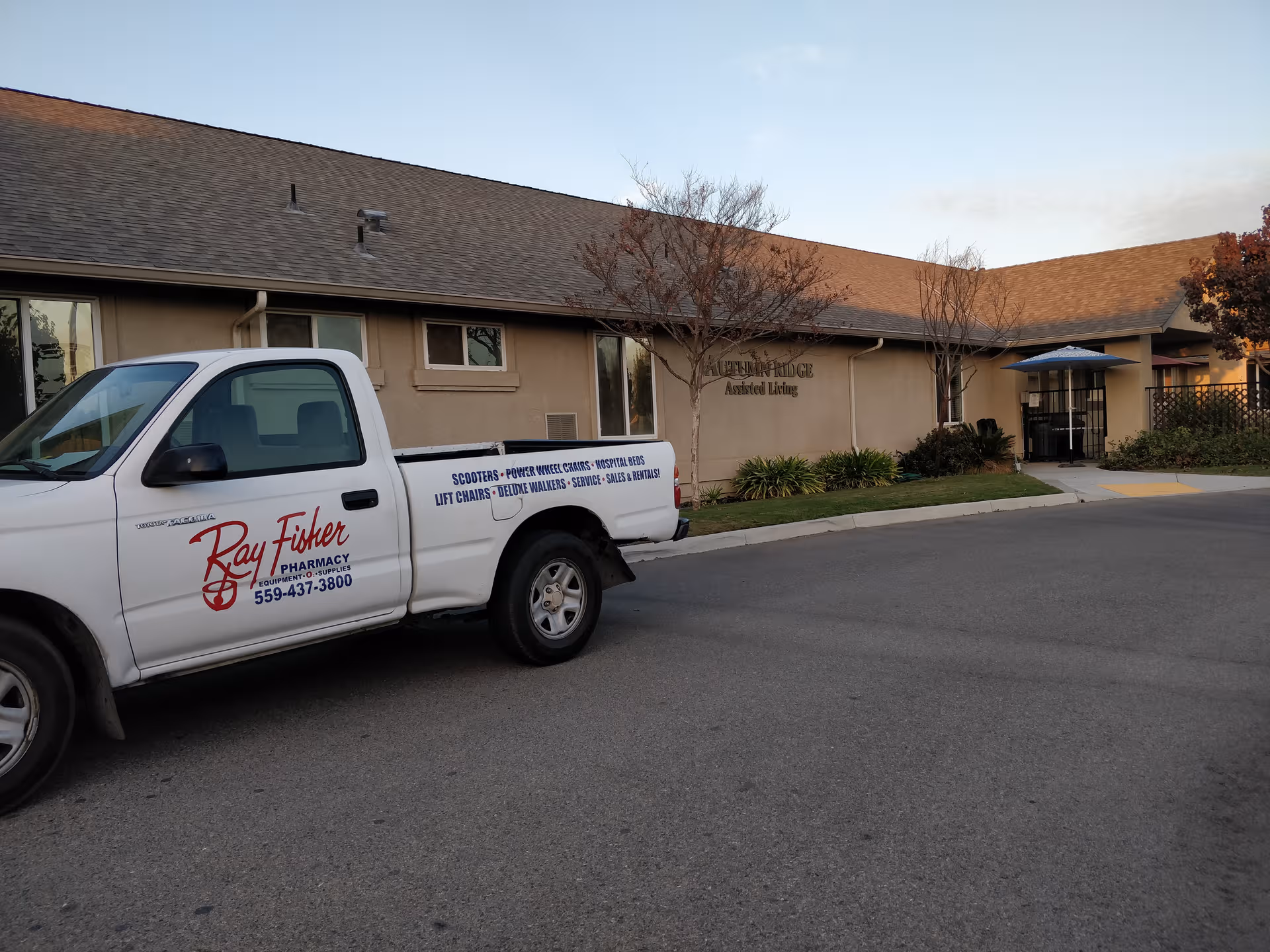 Exterior view of Autumn Ridge Assisted Living building with a white delivery truck parked.