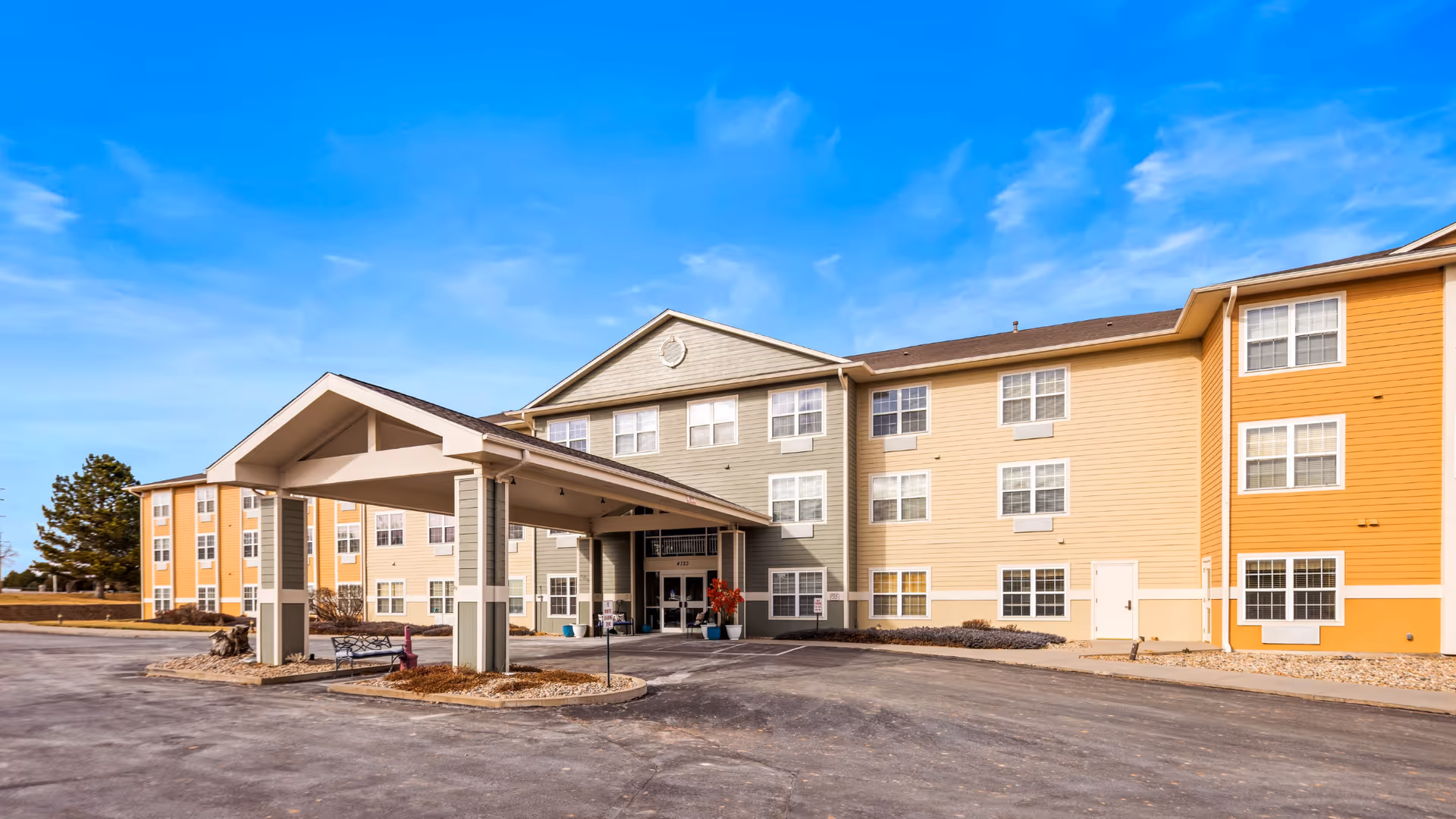 Exterior view of Brookdale El Camino senior living facility with colorful facade and entrance canopy.