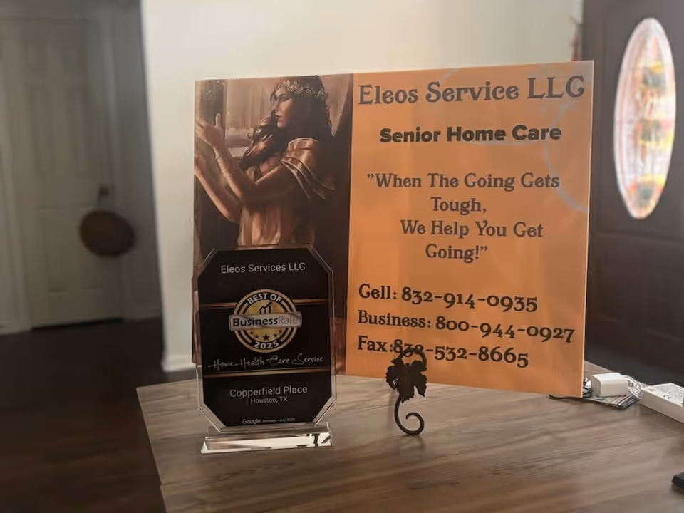 Interior desk setup with Eleos Service LLC sign, plaque, and promotional materials.