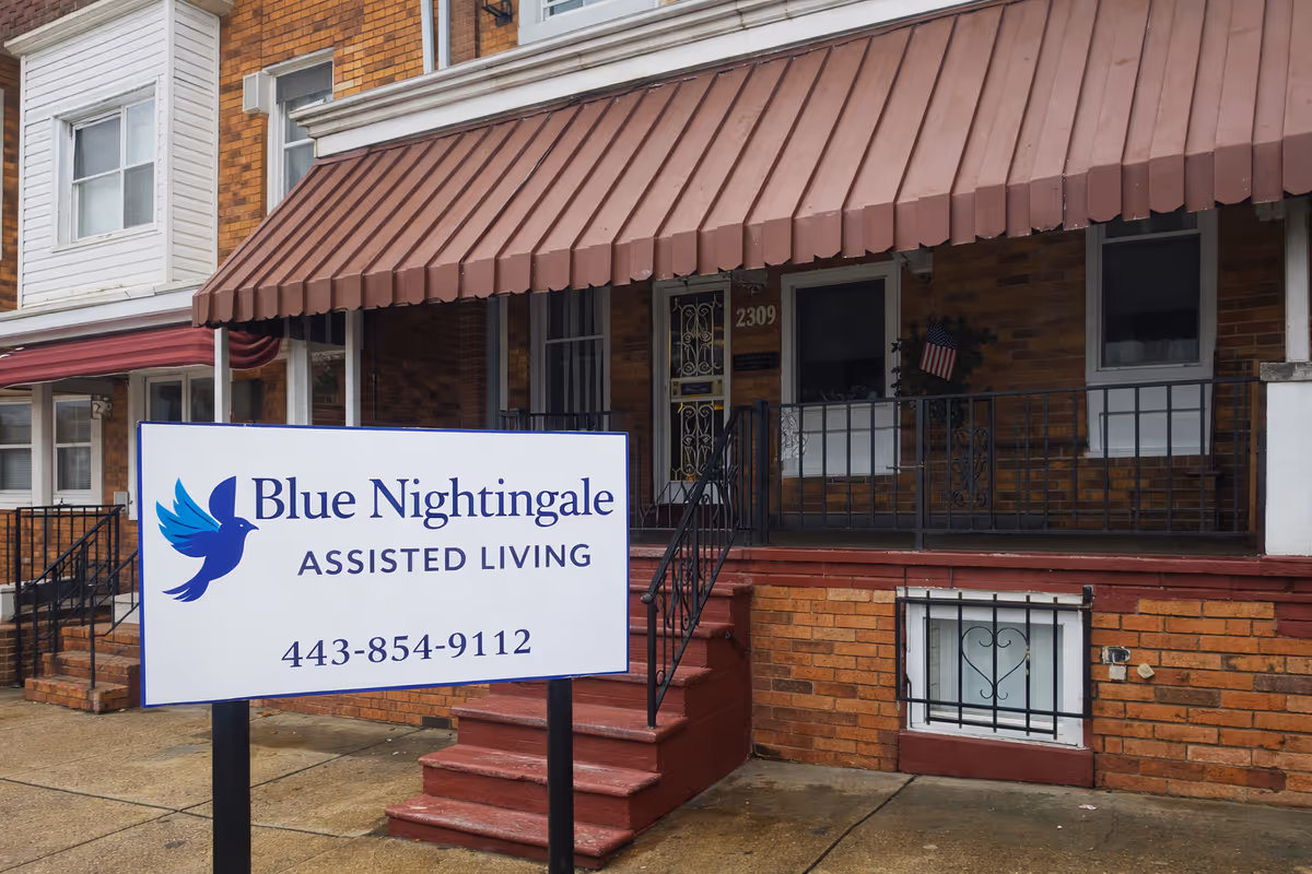 Brick exterior of a senior living facility with a Blue Nightingale Assisted Living sign.