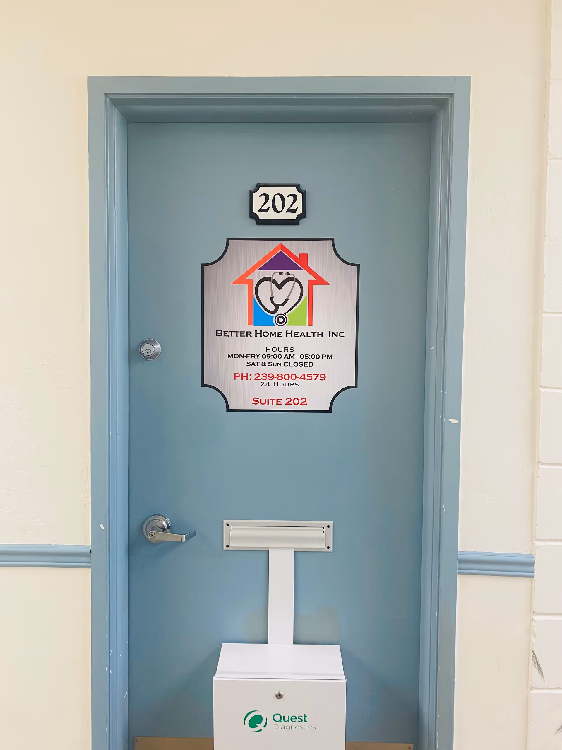 Blue interior door labeled 202 with Better Home Health sign and a Quest Diagnostics box.
