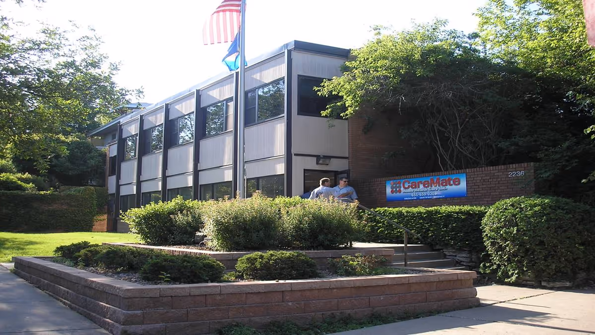 Exterior view of CareMate Home Health Care building with sign and landscaping