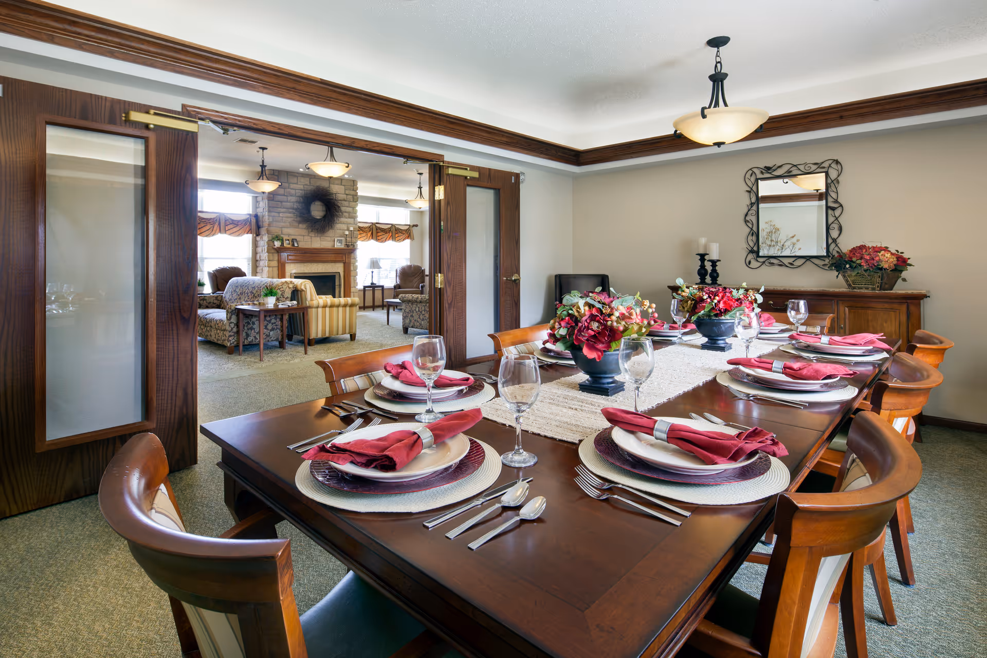A formal dining room with a long wooden table set for a meal