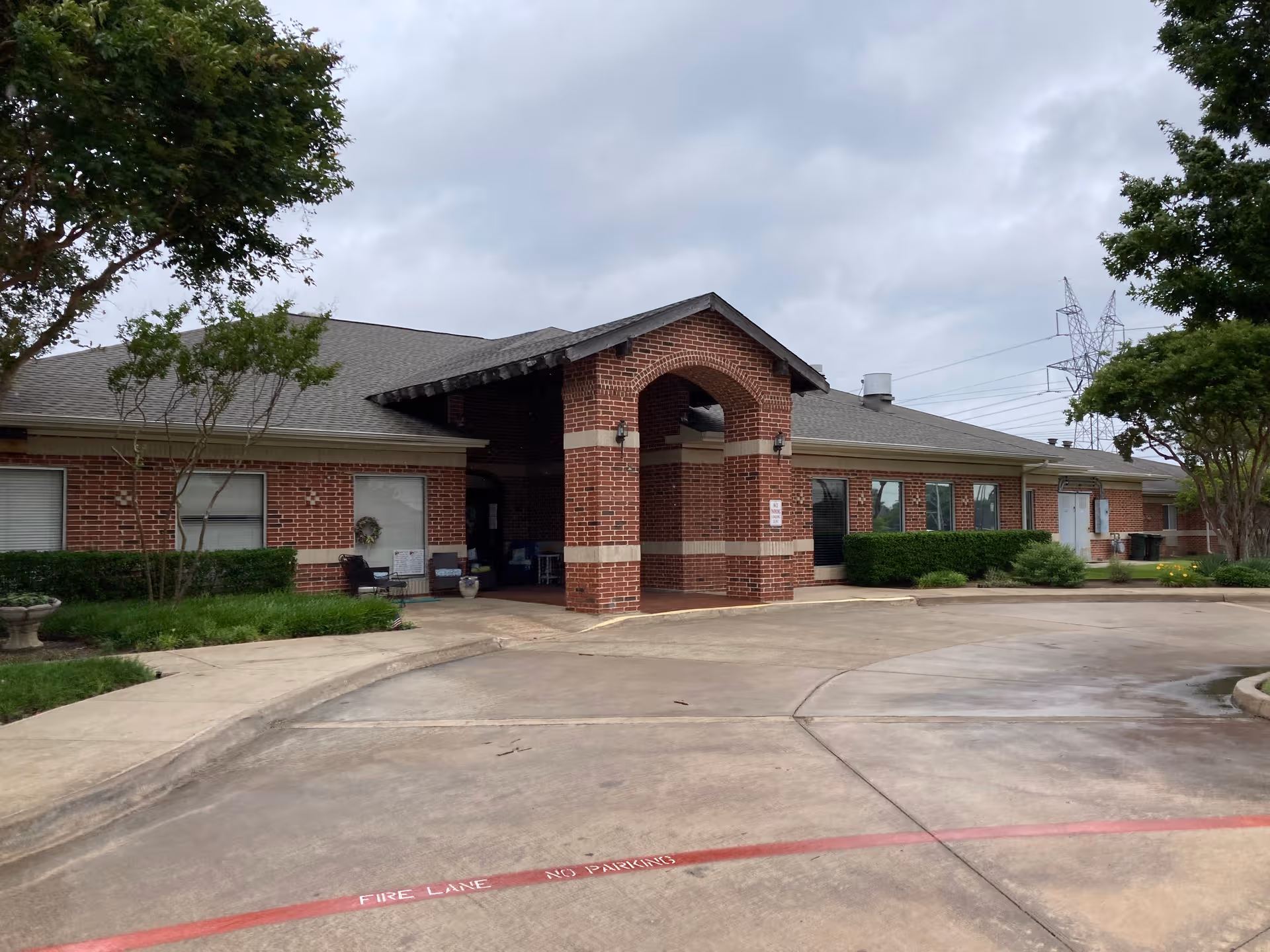 Front exterior of DaySpring Senior Living with brick archway entrance.
