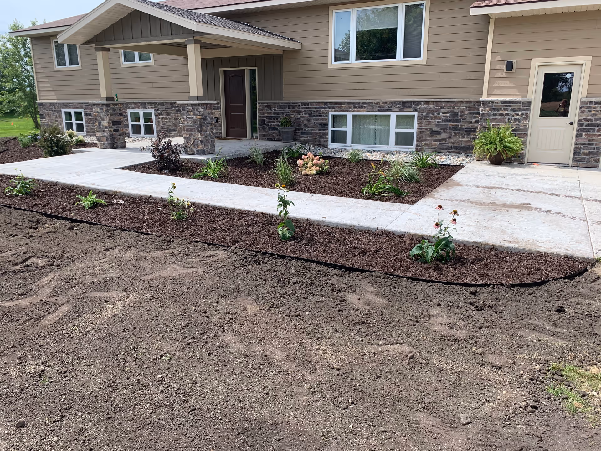 Front exterior of Harmony Home Health Care building with entry and landscaped yard.