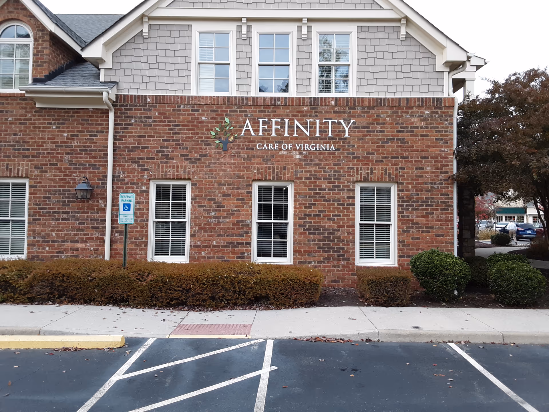 Brick facility with Affinity Care of Virginia sign and windows along a parking lot.