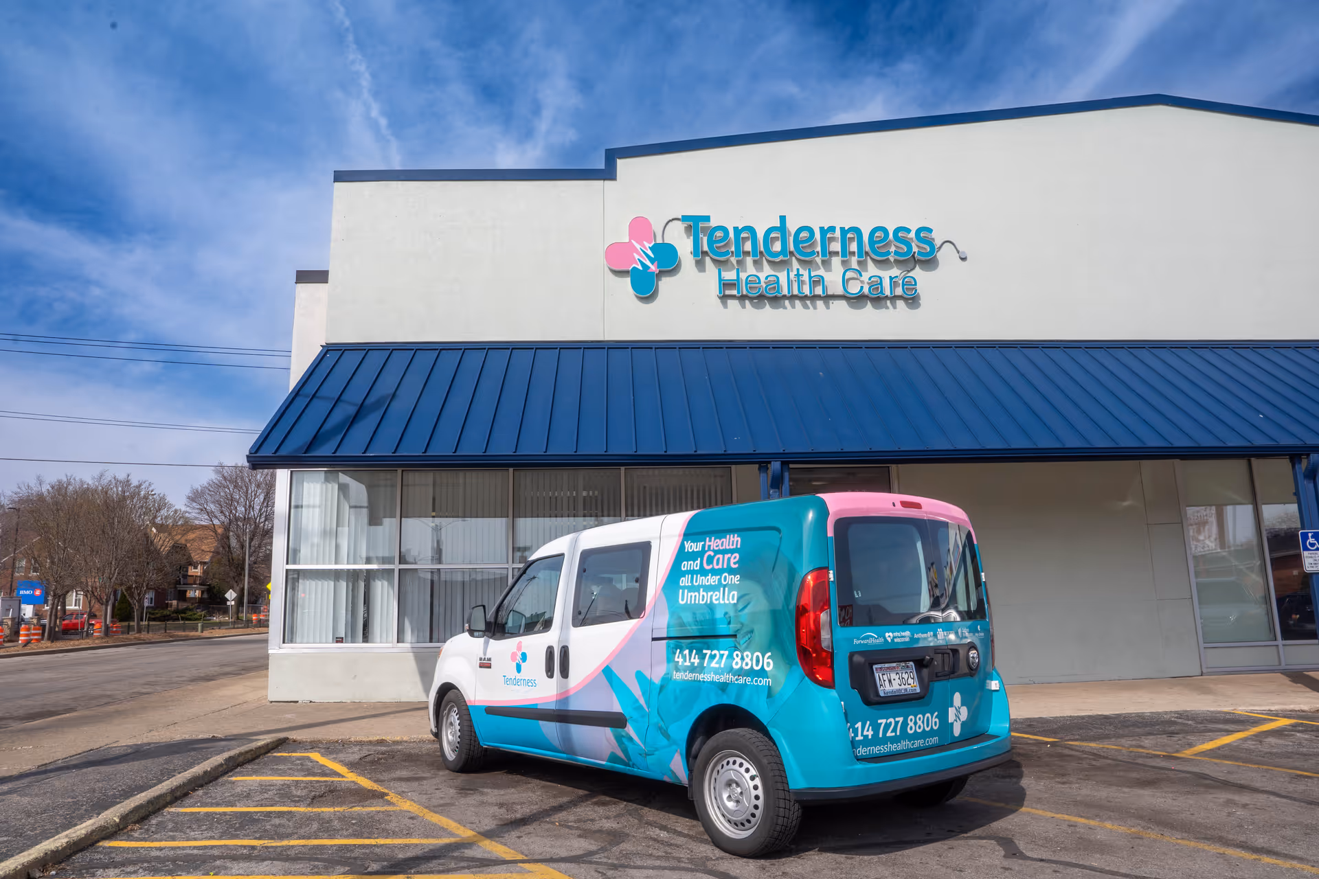 Front view of Tenderness Health Care building with a colorful service van parked outside.
