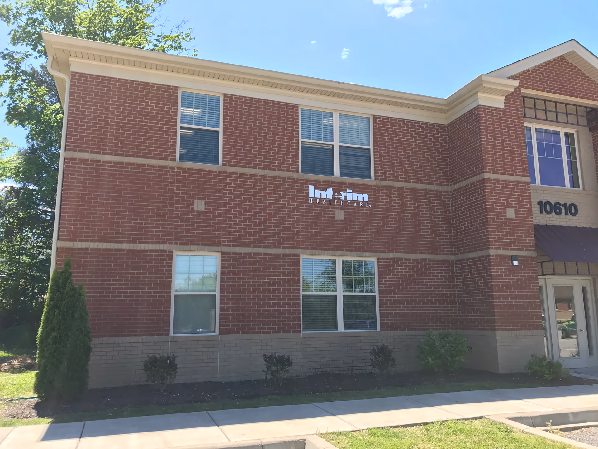 Brick exterior of Interim HealthCare of Louisville building with windows and entrance.