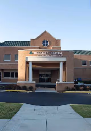 Brick hospital building exterior with a covered entrance and a Middlesex Hospital Cardiac Rehabilitation sign.