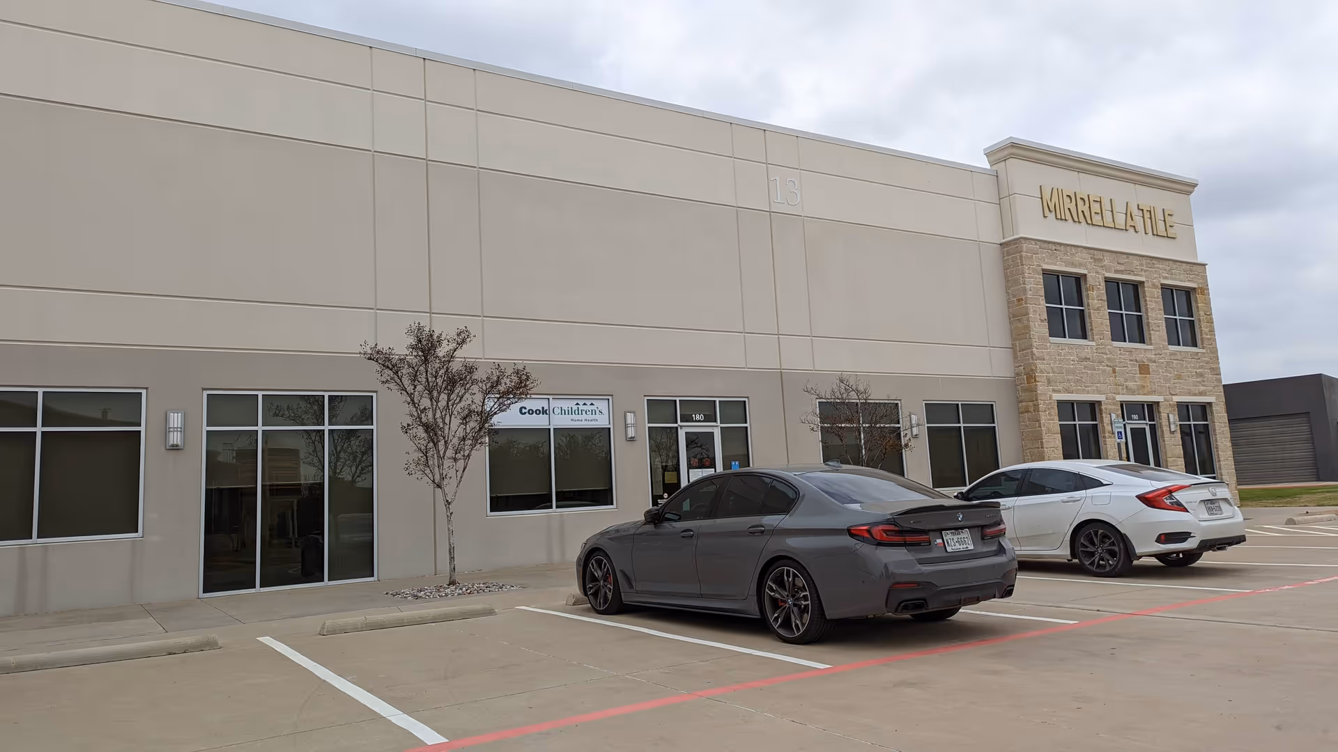 Exterior view of Cook Children's Home Health Allen building with parked cars.