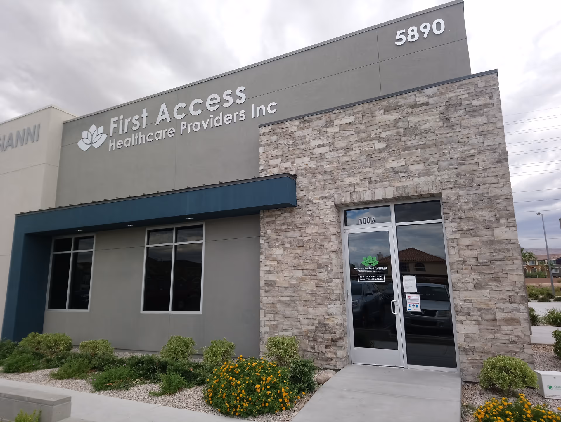 Front view of First Access Healthcare Providers, Inc. building with stone facade and glass entrance.