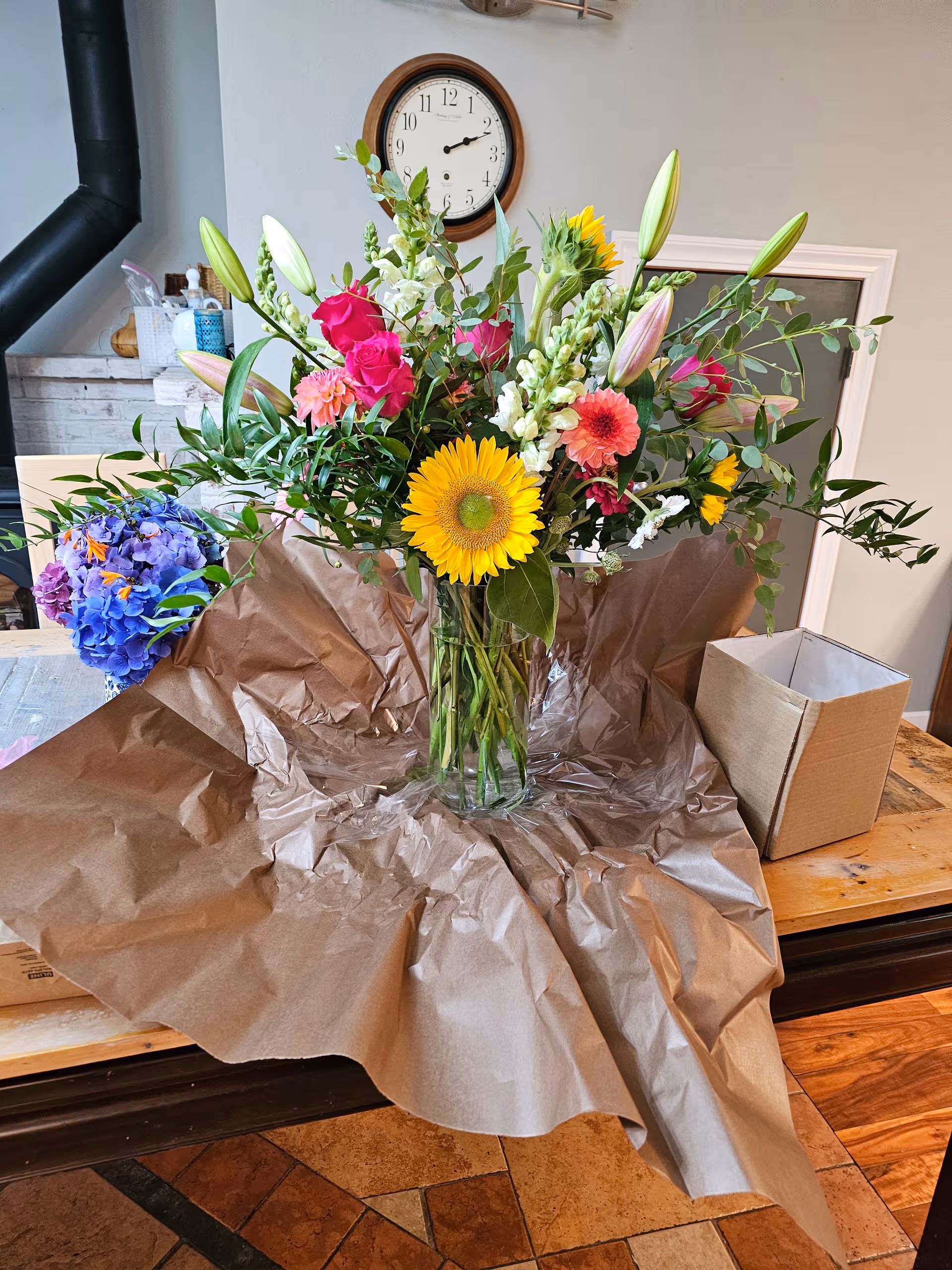 Vibrant bouquet in a glass vase on a table indoors.