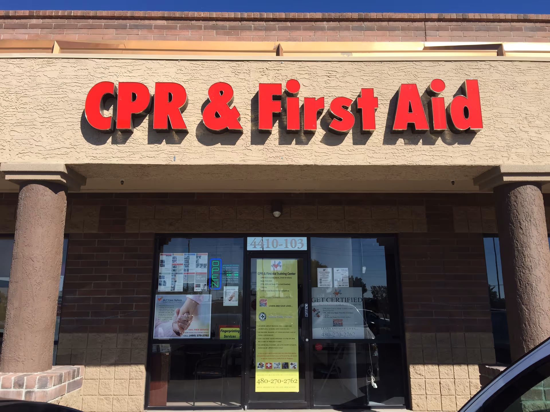 Exterior view of a CPR and First Aid Training Center storefront with a large red sign.