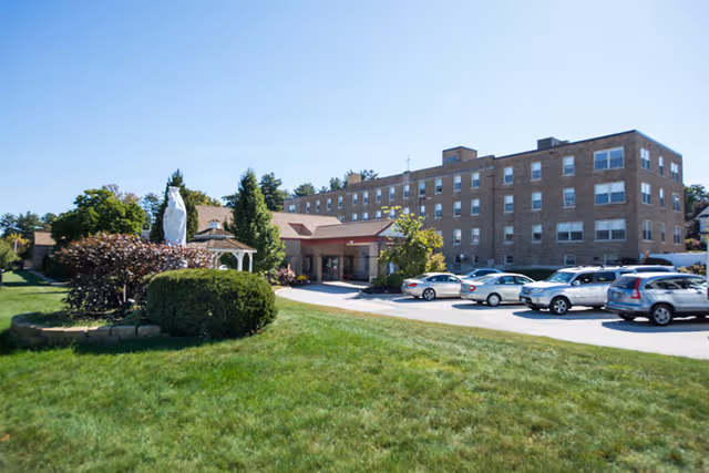 Exterior view of St. Teresa Rehabilitation and Nursing Center with parked cars